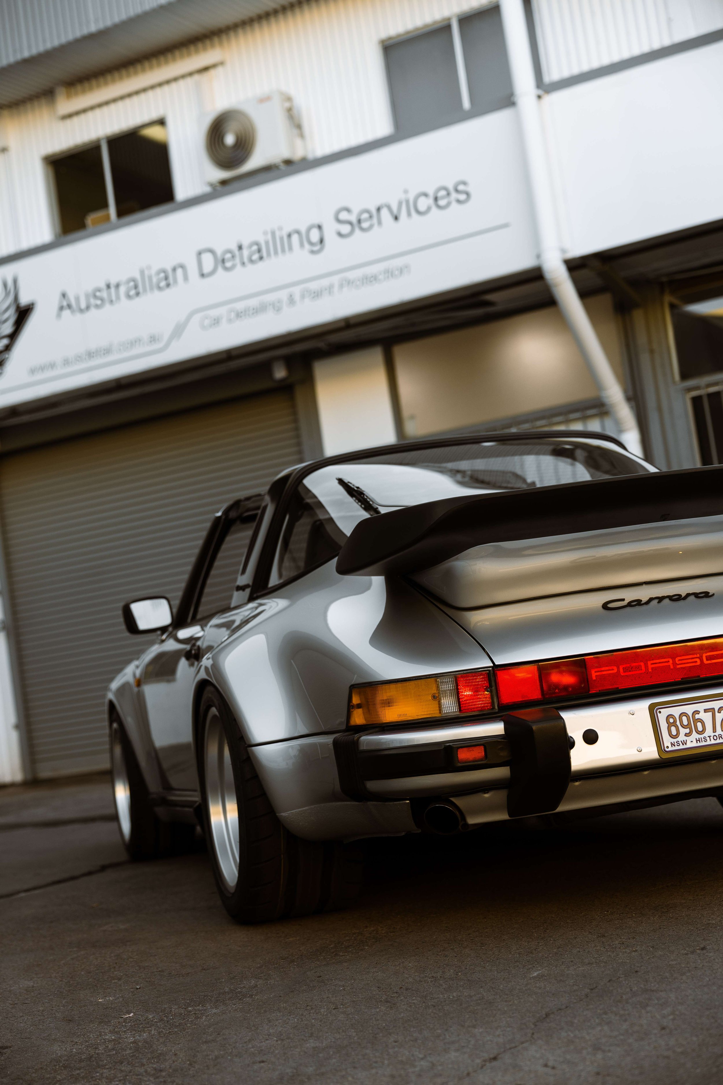 Silver 1989 Porsche 911 Carrera Targa rear whale tail and Carrera badge in Mona Vale