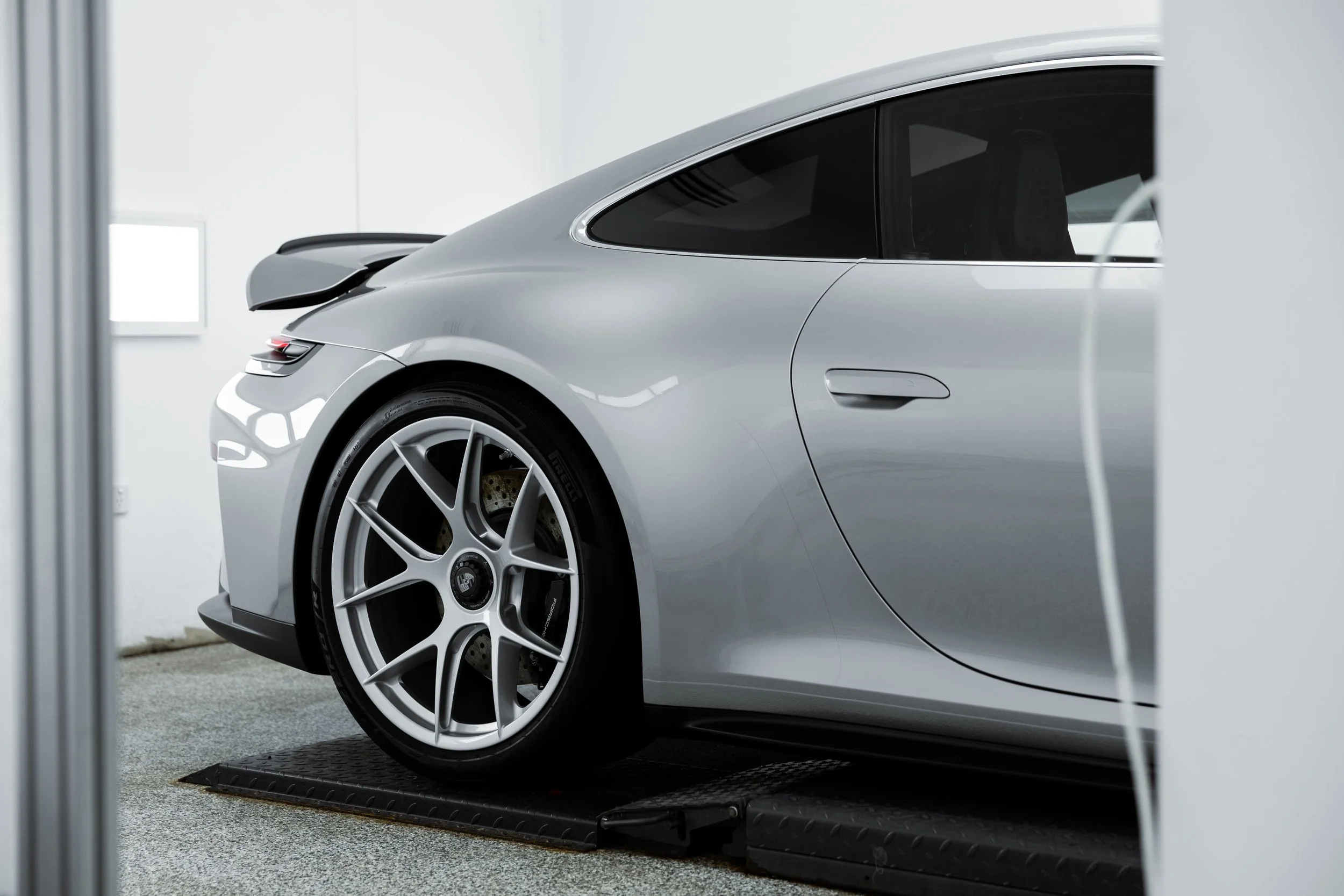 Silver Porsche 911 GT3 Touring rear quarter view highlighting wide stance, rear wheel and subtle rear wing, finished with high-gloss protection by Australian Detailing Services Sydney