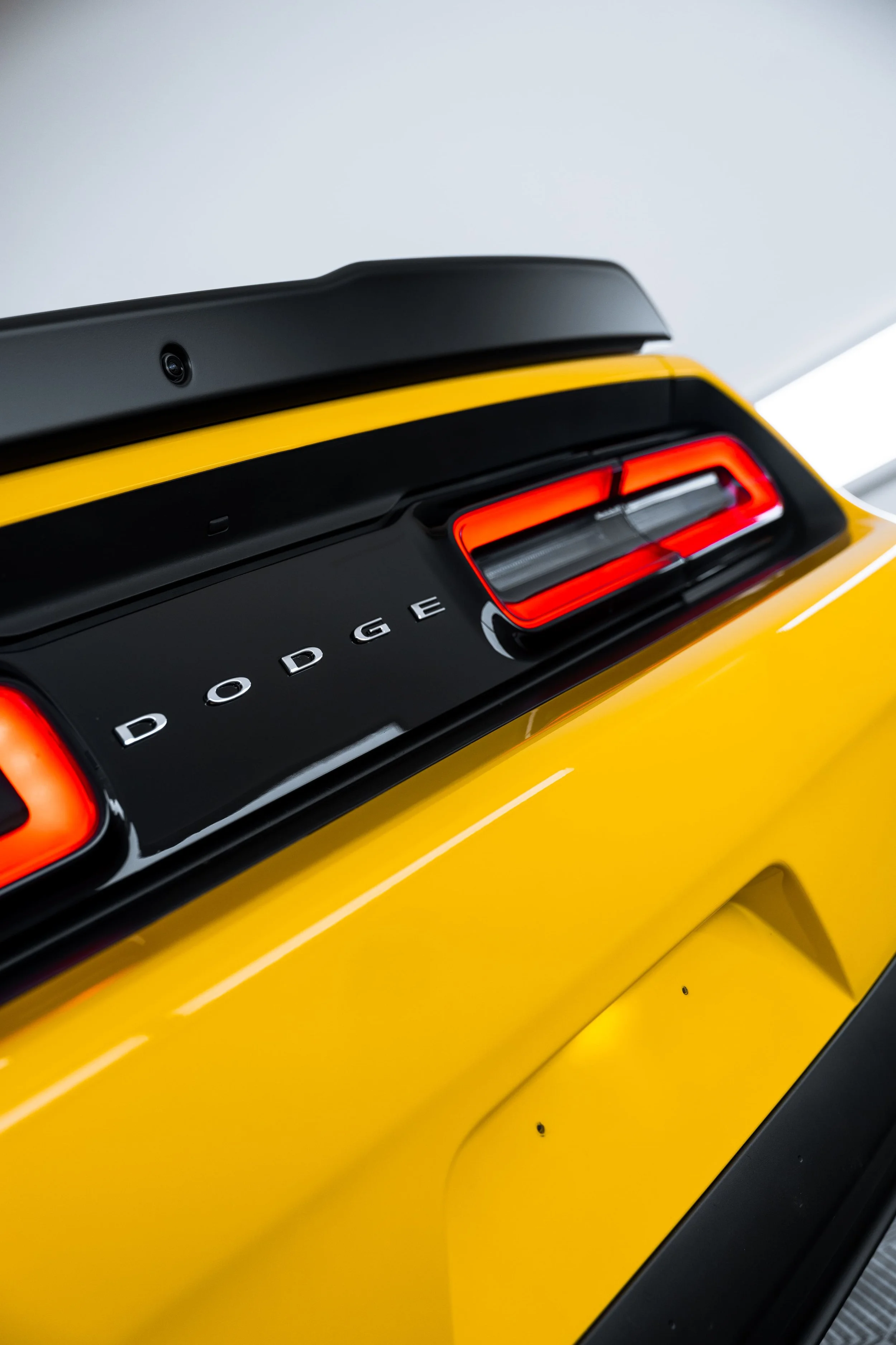 Close-up of yellow Dodge Challenger SRT Demon rear tail light and Dodge badge with PPF by ADS in Mona Vale