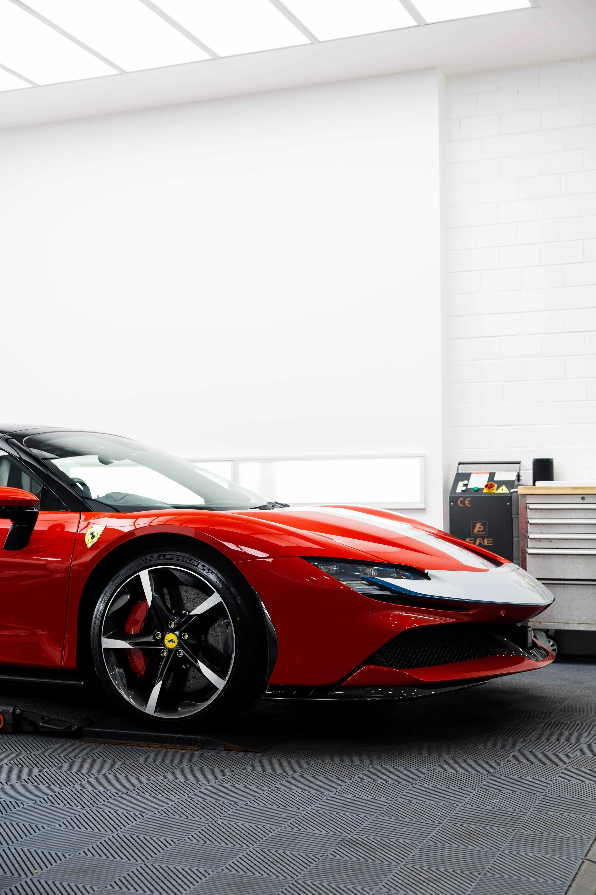 Red Ferrari SF90 Spyder front three quarter with white stripe and XPEL Paint Protection Film in Mona Vale