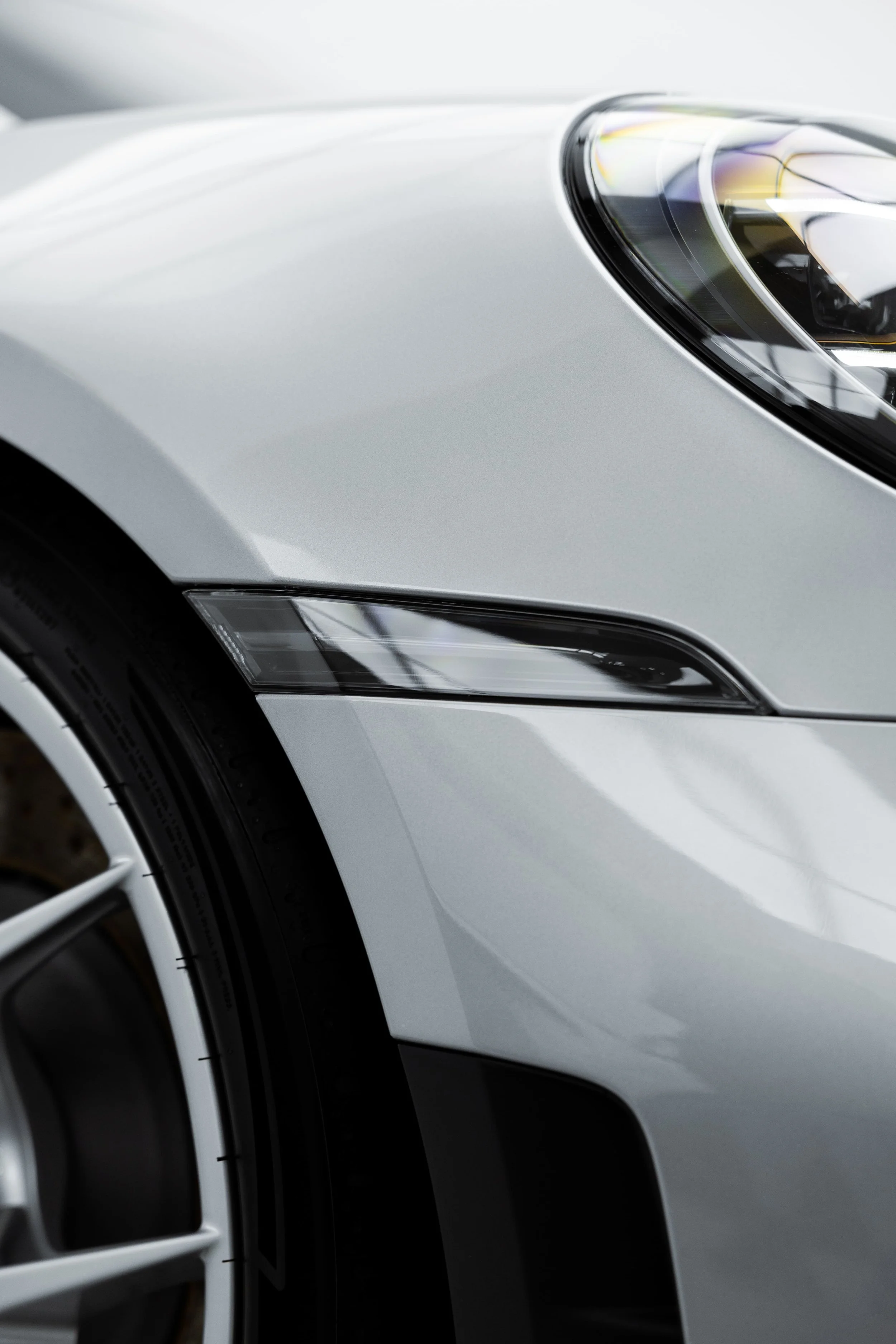 Porsche 911 GT3 Touring front headlight and fender detail in white, showcasing smooth body lines protected by PPF by Australian Detailing Services Sydney