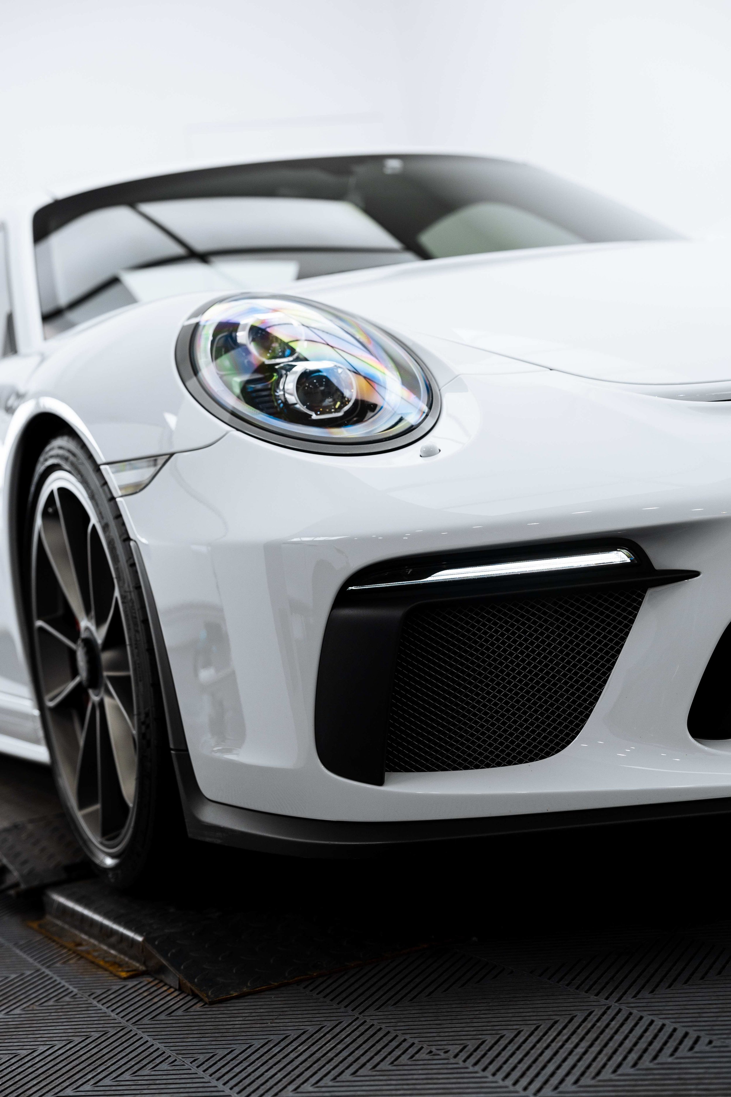 White Porsche GT3 front quarter and headlight with XPEL Paint Protection Film in Sydney