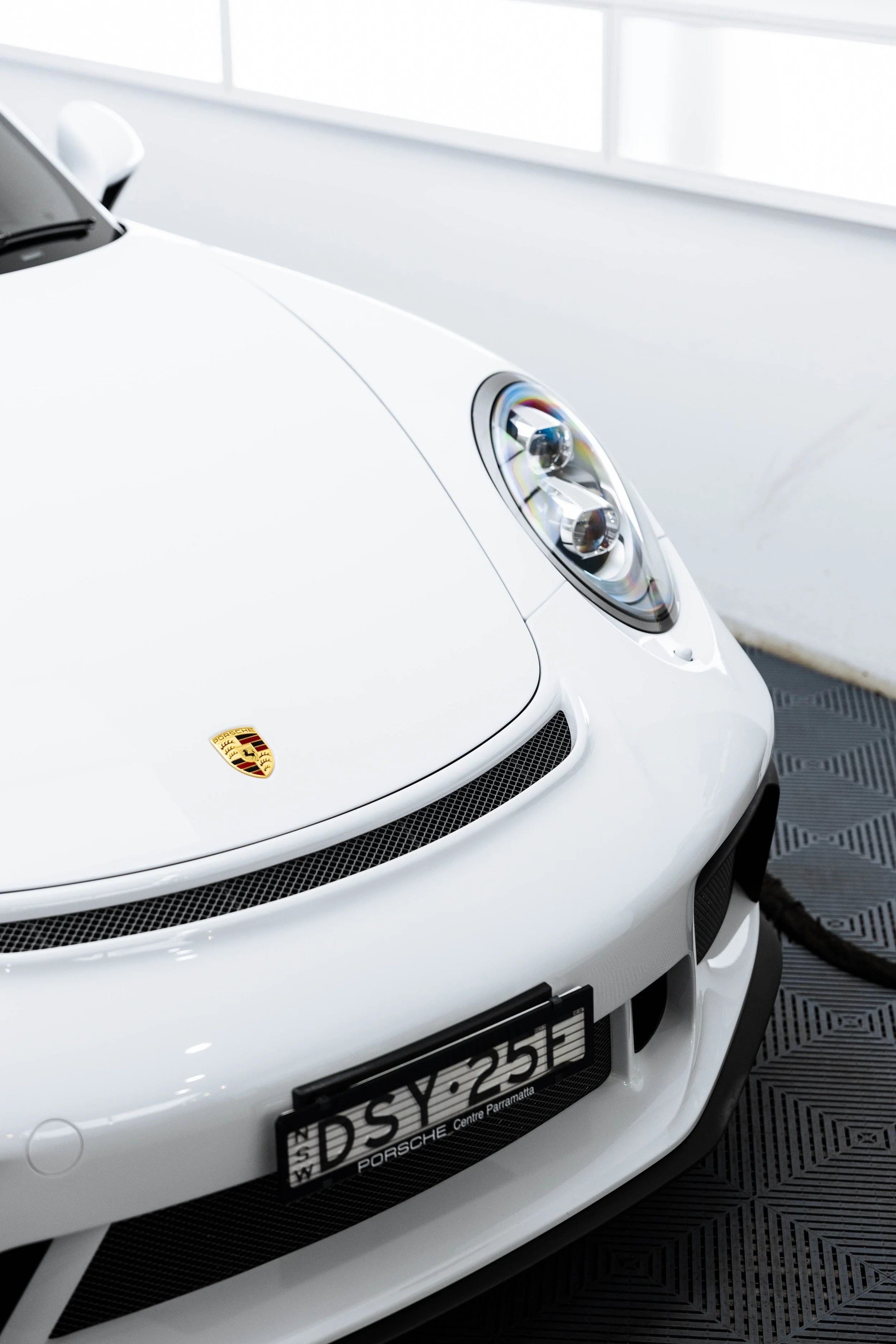 White Porsche GT3 front badge and headlight with XPEL Paint Protection Film in Sydney