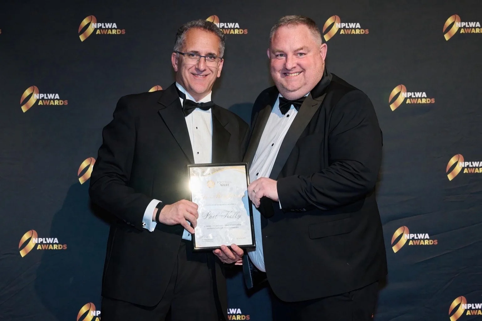 Phil Kelly receiving Football West Life Membership from Football West Chairman Sherif Andrawes.