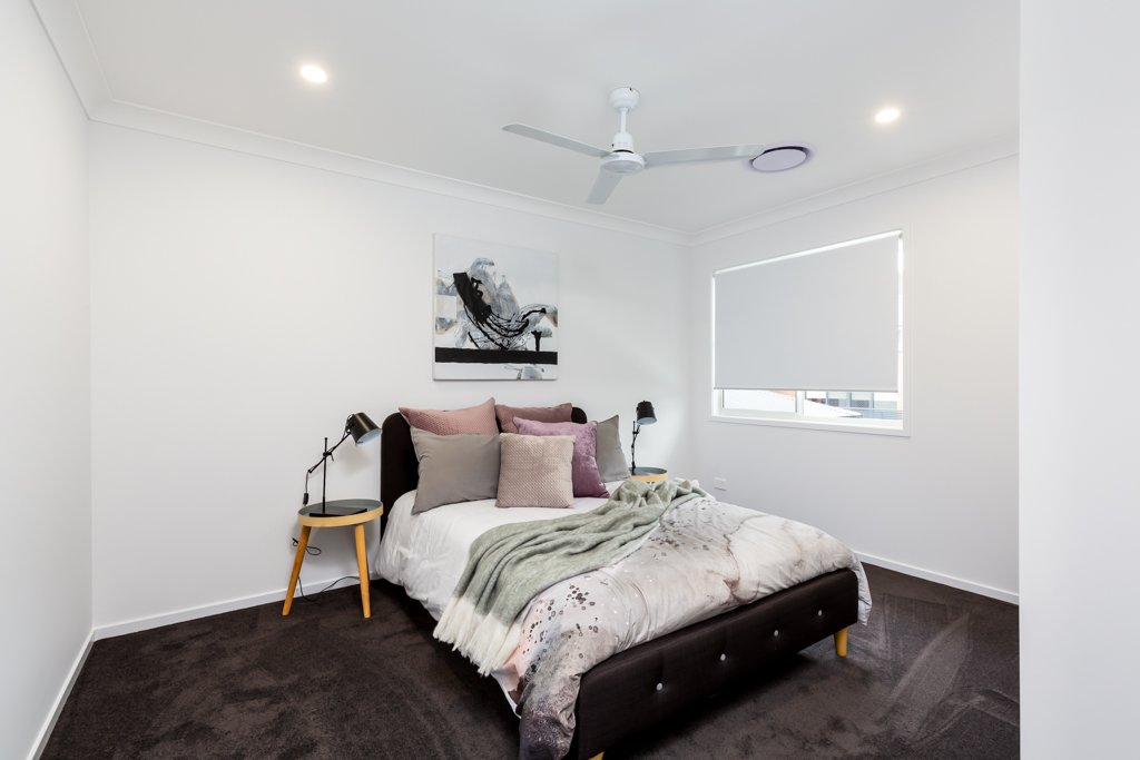 Bedroom with ceiling fan and double bed and bedside table_Carnelian Projects.jpg