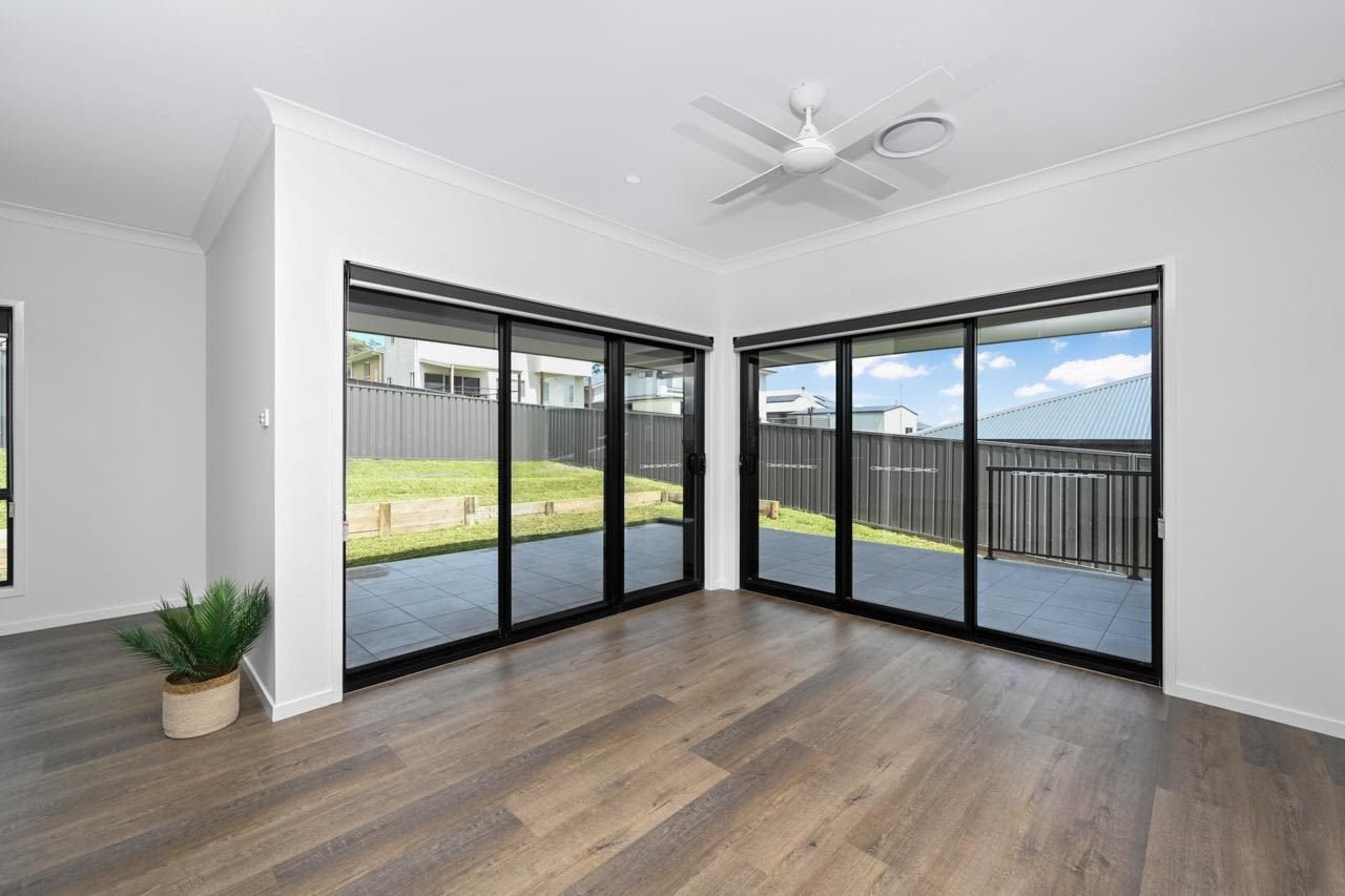 Dining area with wooden laminate flooring and sliding doors to patio_Carnelian Projects.jpg