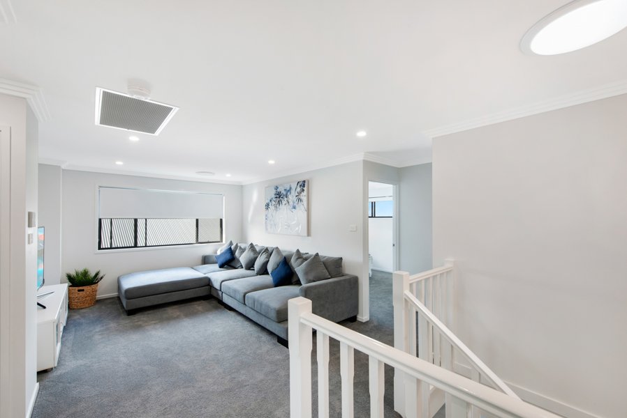 Upstairs living room  with grey carpet and sofa_Carnelian Projects.jpg