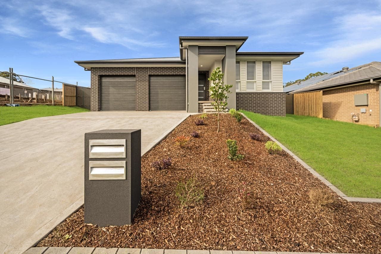 Dark brown brick home with dark letterbox and concrete driveway_Carnelian Projects.jpg