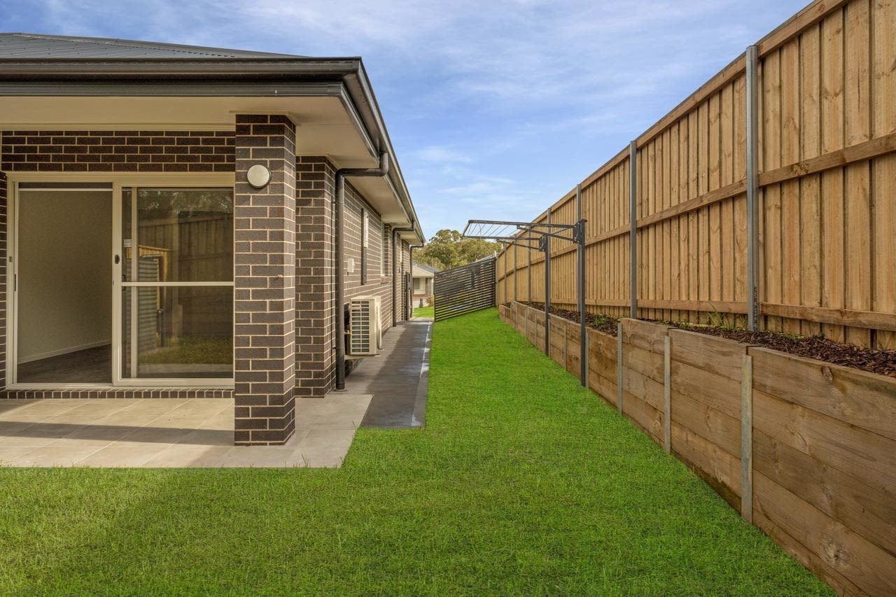 Brick house with fence, landscaping and patio_Carnelian Projects.jpg