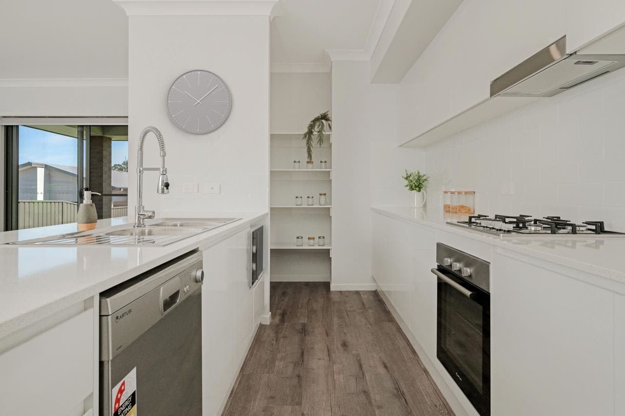 White kitchen with butlers pantry shelving and wooden laminate flooring_Carnelian Projects.jpg