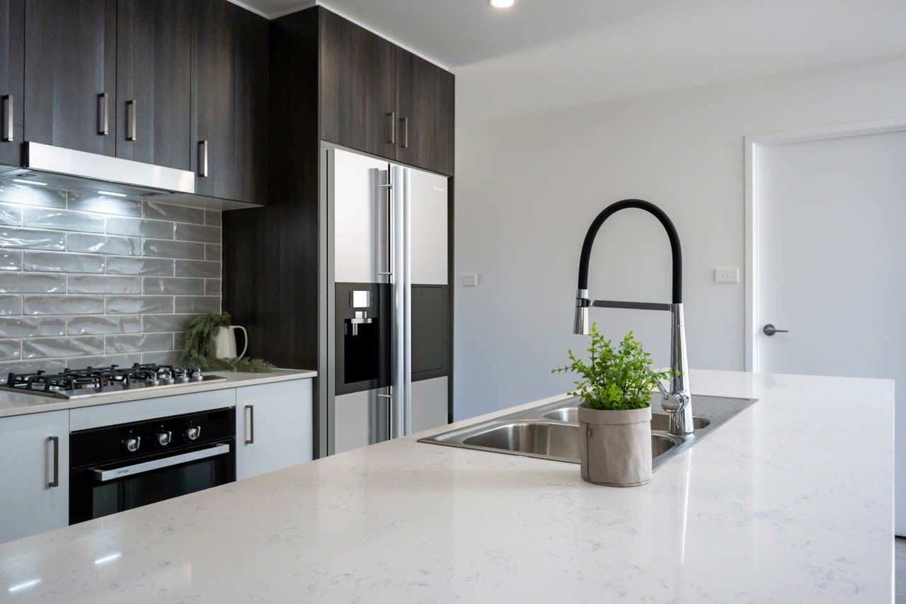 Kitchen with dark wooden cabinetry, gooseneck tap _Carnelian Projects gooseneck tap.jpg