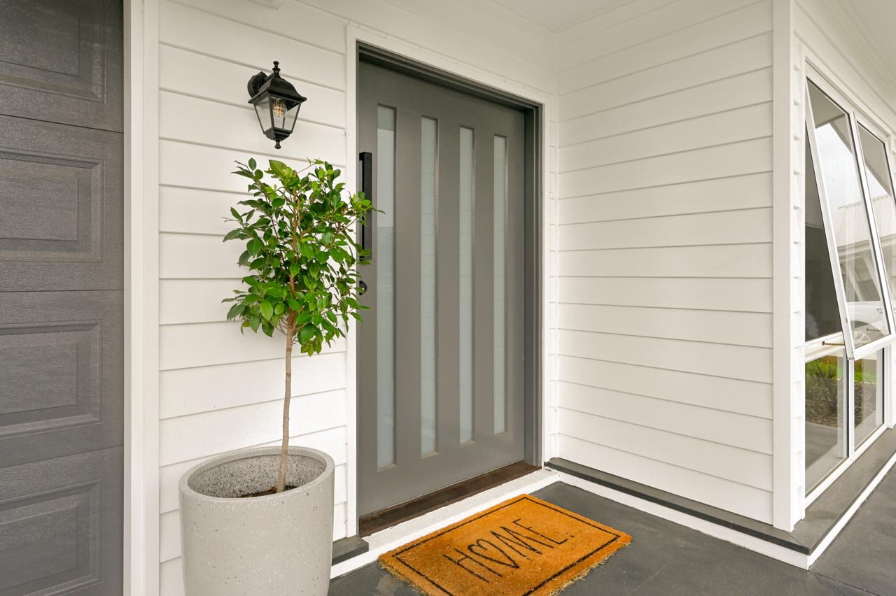 Hamptons style cladding on house with grey front door.jpg