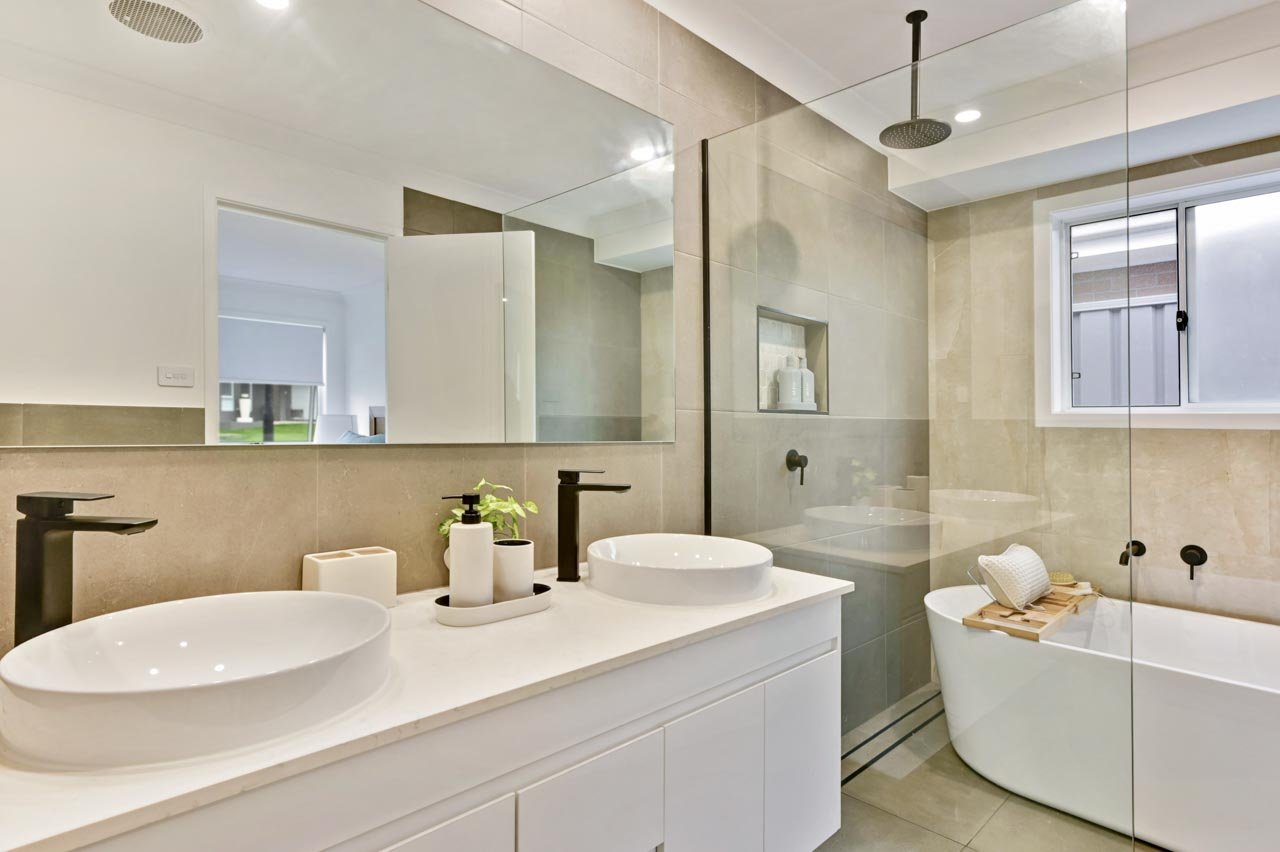 Ensuite bathrom with white vanity and beige tiles.jpg