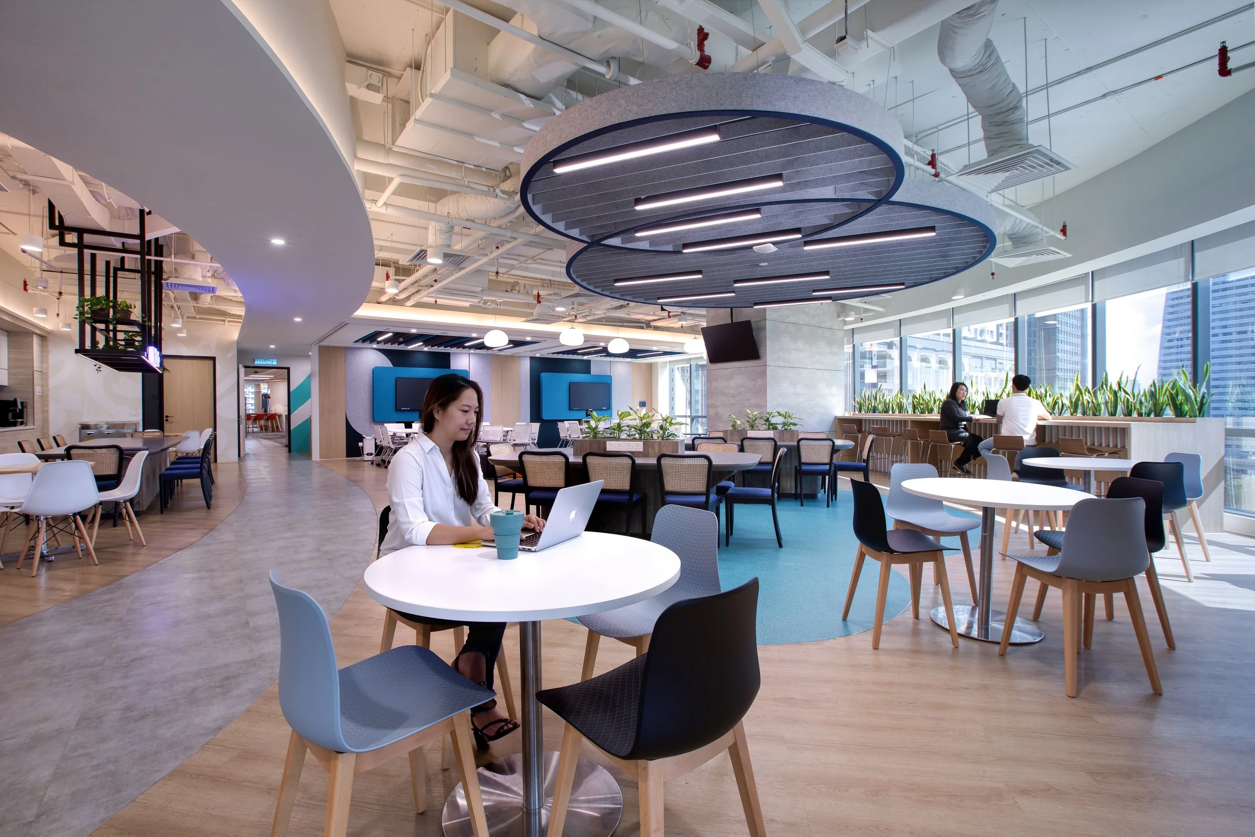 Unilever office, Kuala Lumpur, Malaysia. Person working on her laptop at a table