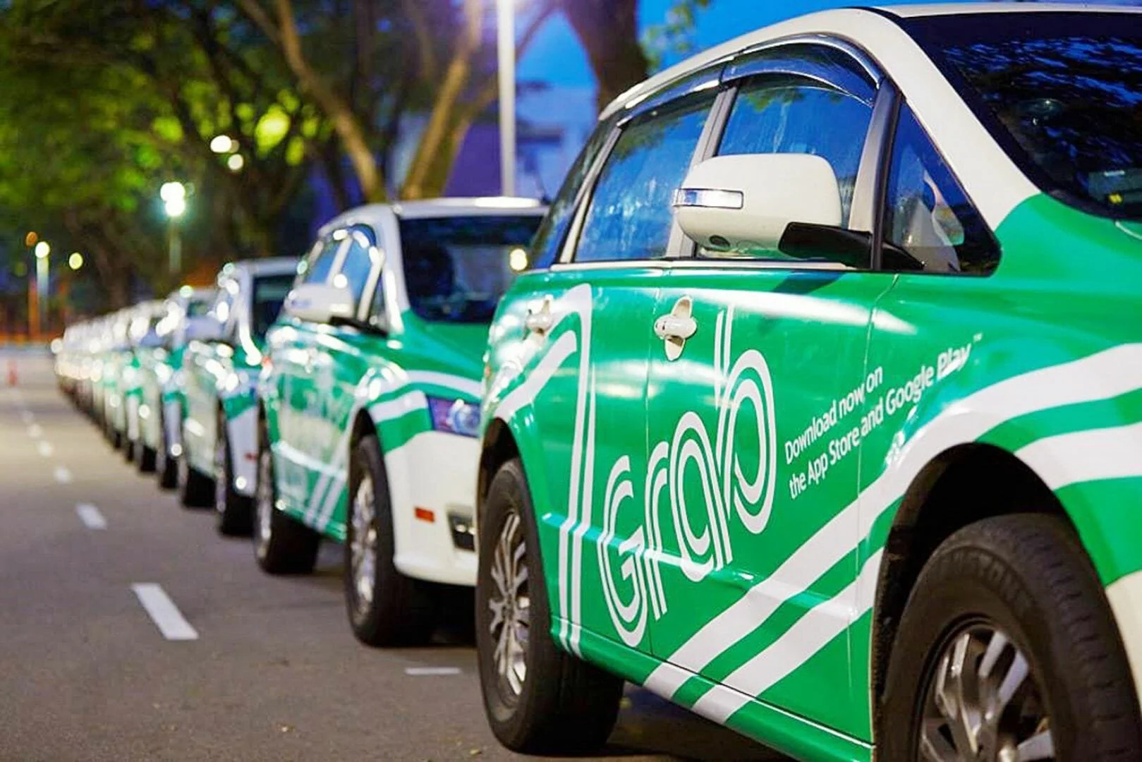 Grab, Kuala Lumpur, Malaysia, delivery cars parked in the street and branded with the Grab logo and green colour