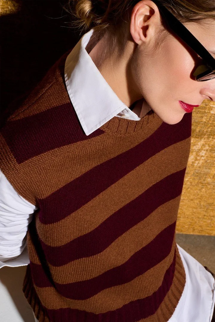 A refined knit vest in warm tobacco and deep burgundy &mdash; effortless over a crisp white shirt, made for that perfectly undone pre-fall attitude.

BE YOU &mdash; Cotswold Fields Pre-Fall 2026