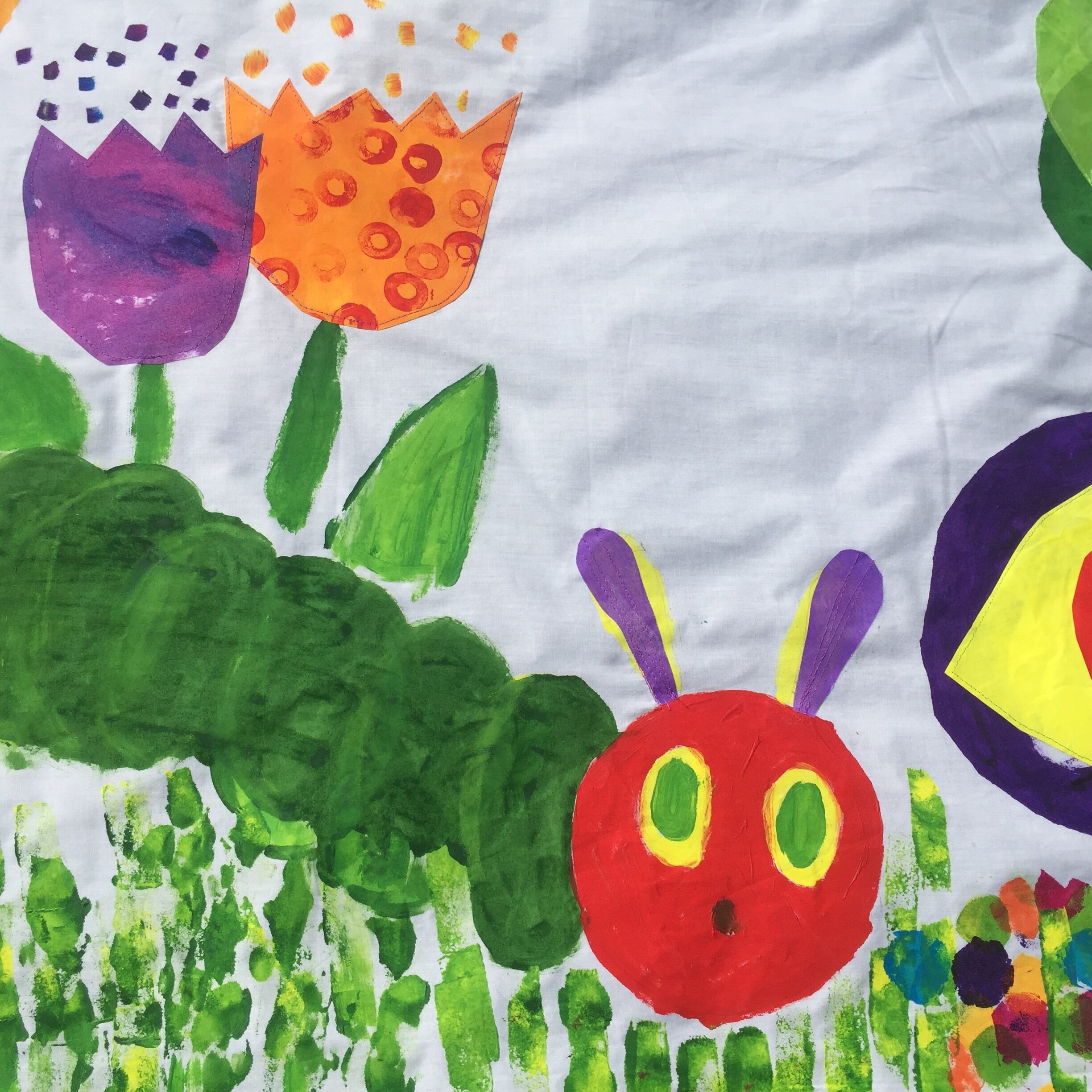 children used the sewing machine to create decorative stitches on the grasses across the piece