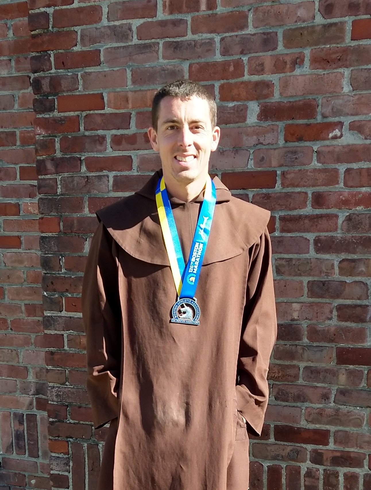 Br. John Mary with Marathon medal.jpg