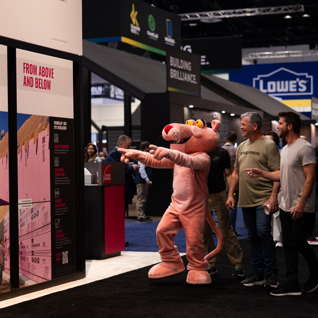 Tony the Pink Panther mascot engaging visitors at the Owens Corning IBS 2026 exhibit