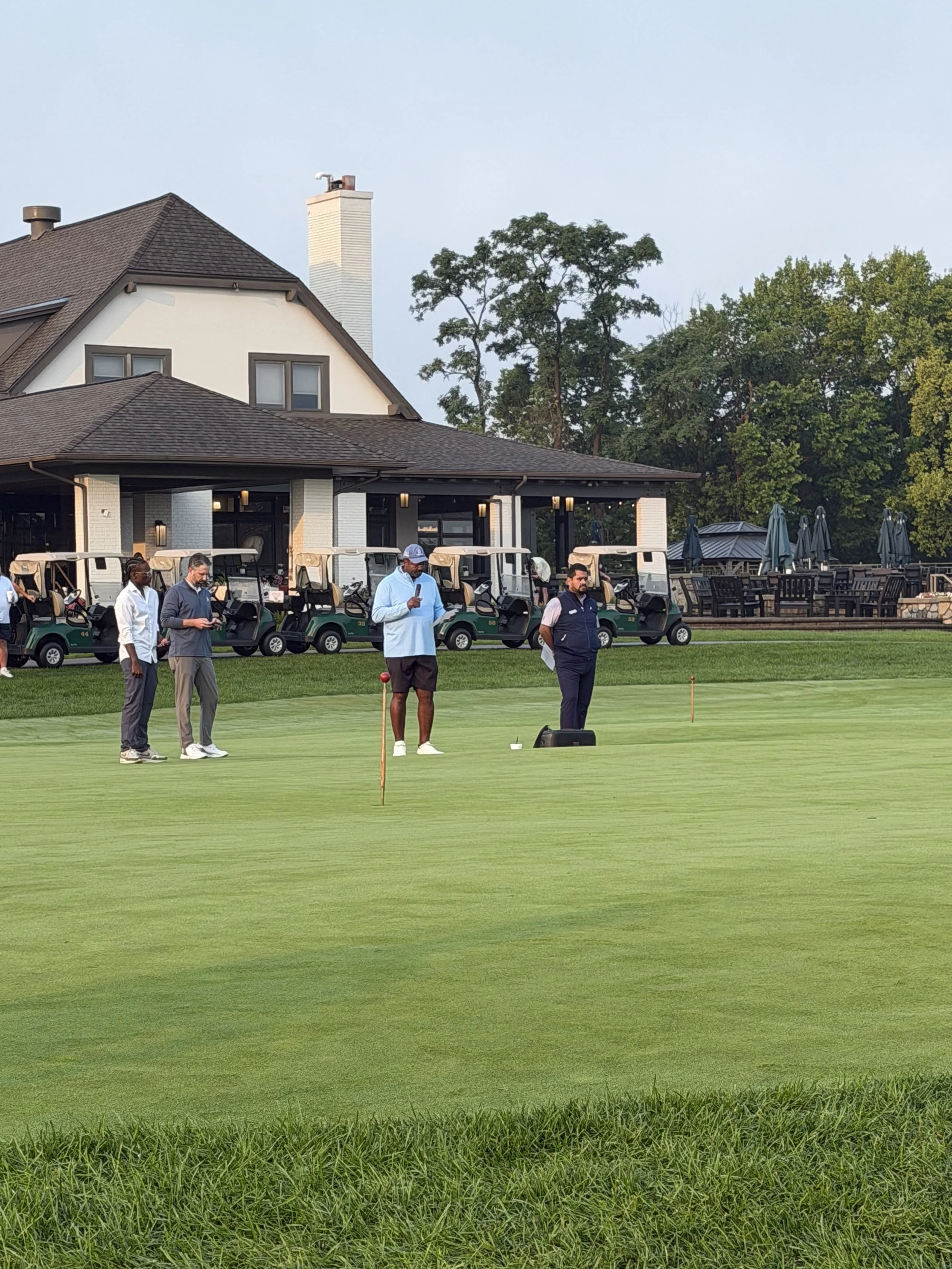 Golf outing participants gather on the putting green during the 2026 Walt Gutowski Sr. YMCA Golf Outing at Blythefield Country Club.
