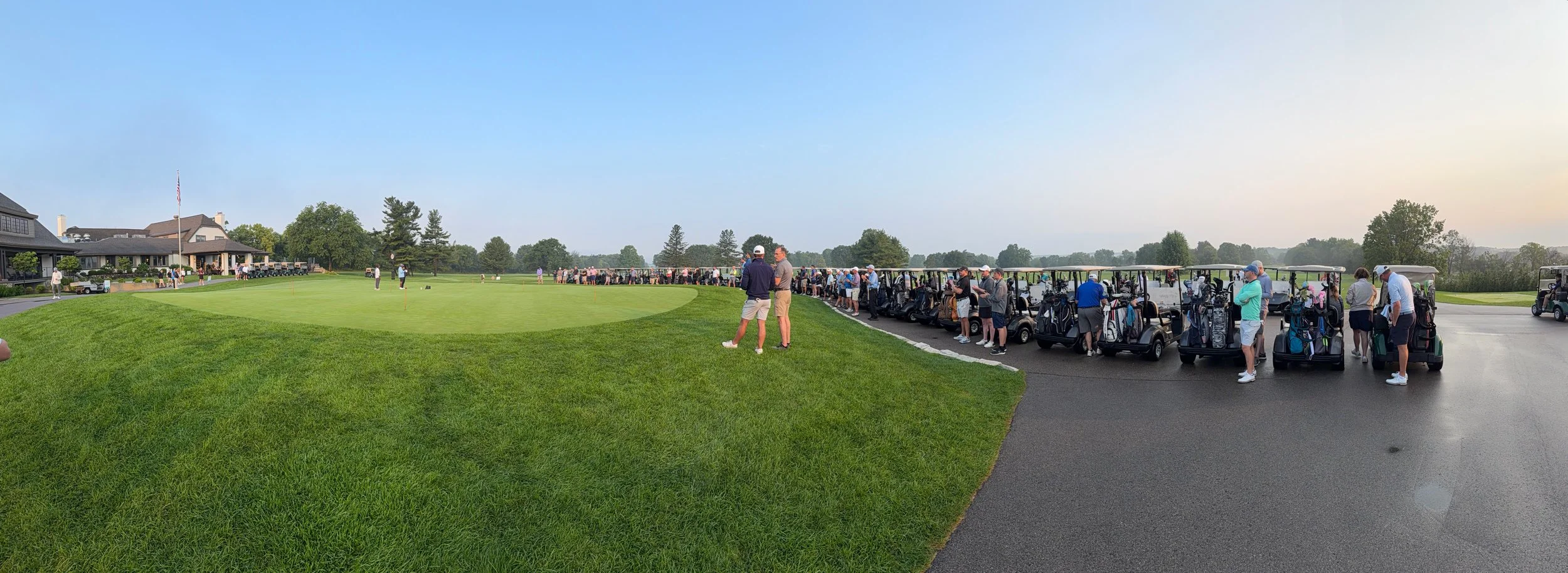 Golfers and golf carts line up around the practice green for the 2026 Walt Gutowski Sr. YMCA Golf Outing at Blythefield Country Club.