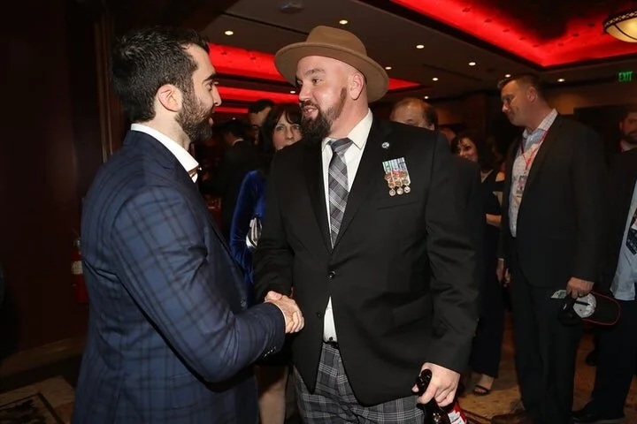 Army veteran and Newark, NJ resident Adam Hudson meets Kyle Palmieri. (Photo Credits: Andrew Mordzynski)