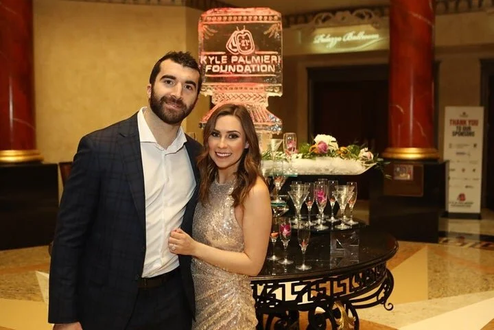 Kyle Palmieri and his wife Ashlee Casper Palmieri pose for a photo at the 2nd Annual Military Ball. (Photo Credits: Andrew Mordzynski)