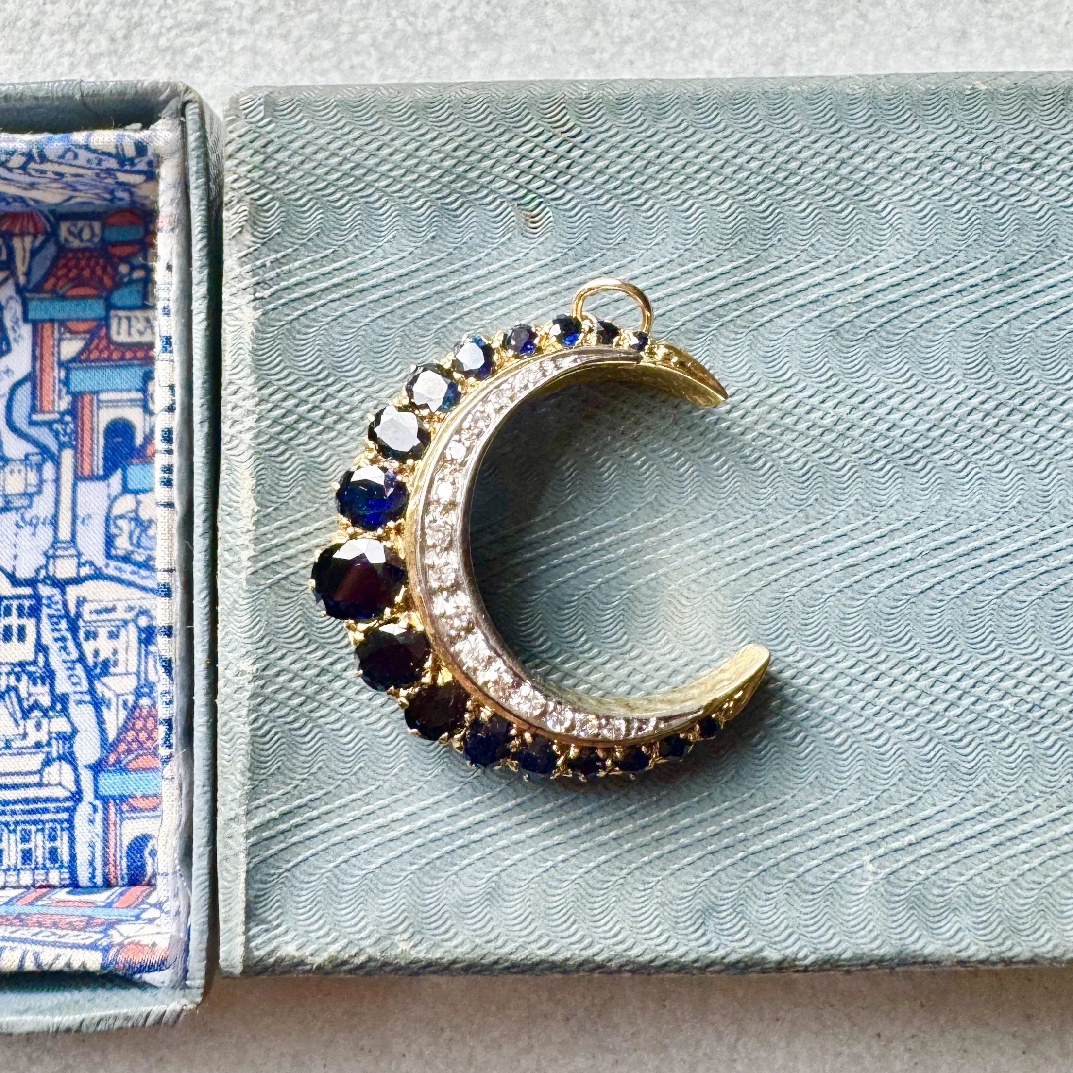 A Sapphire & Diamond Crescent Pendant in 18ct Gold
