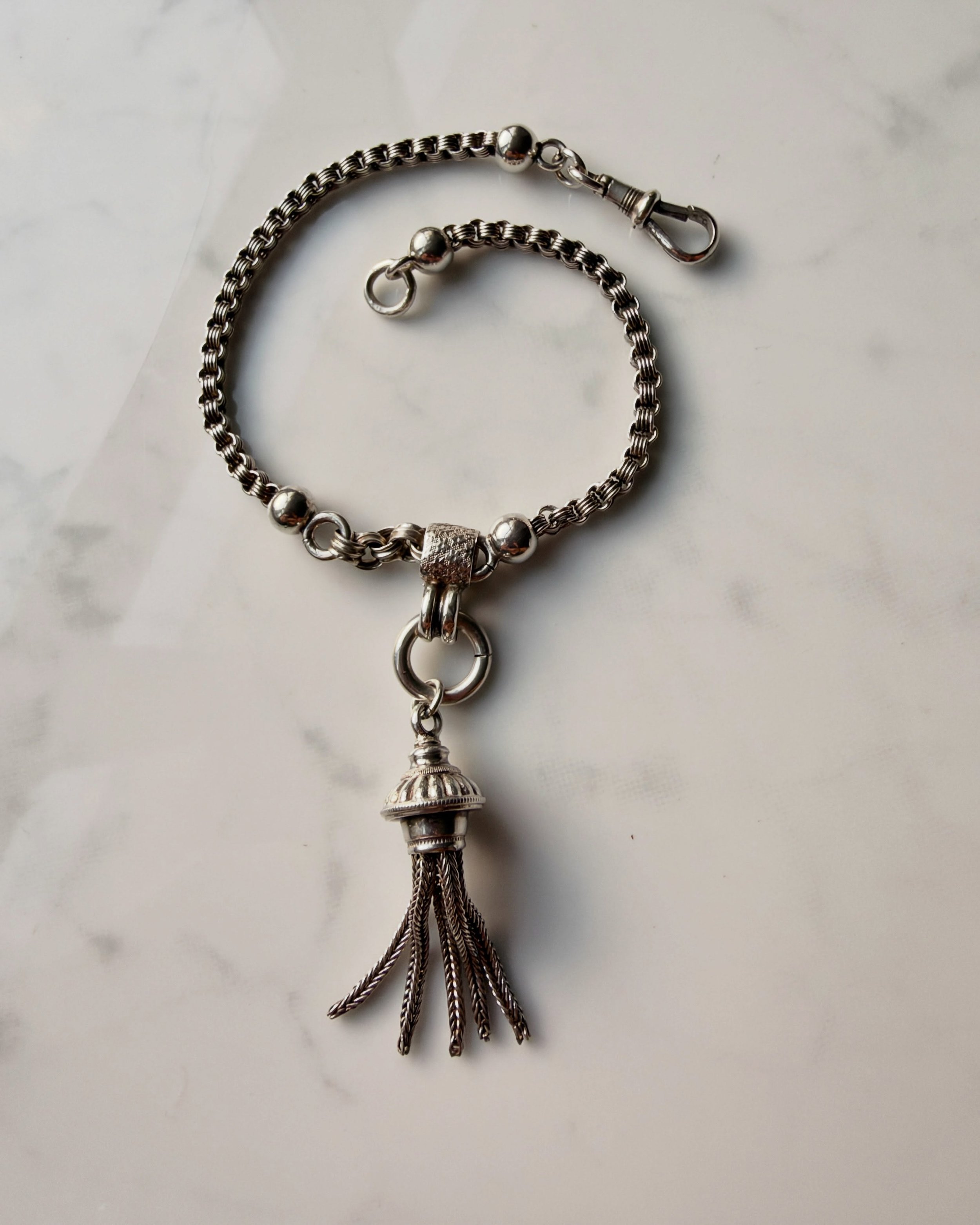 Anyone else love a tassel? Add some ball accents and I&rsquo;m hooked! Here we have a lovely silver Victorian Albertina - wear it as a bracelet or use the dog clip clasp to clip it to another chain as an extender, the choice is yours.
As always detai