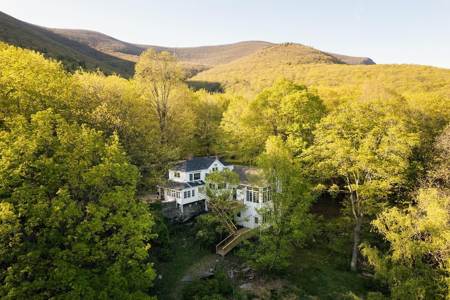 Meet the incredible Silver Wings Compound in Woodstock. This extremely special property is located on a private road with hiking trail, pond and pool, along with multiple structures including a guest house, artist studio, barn, and pool house. The ho