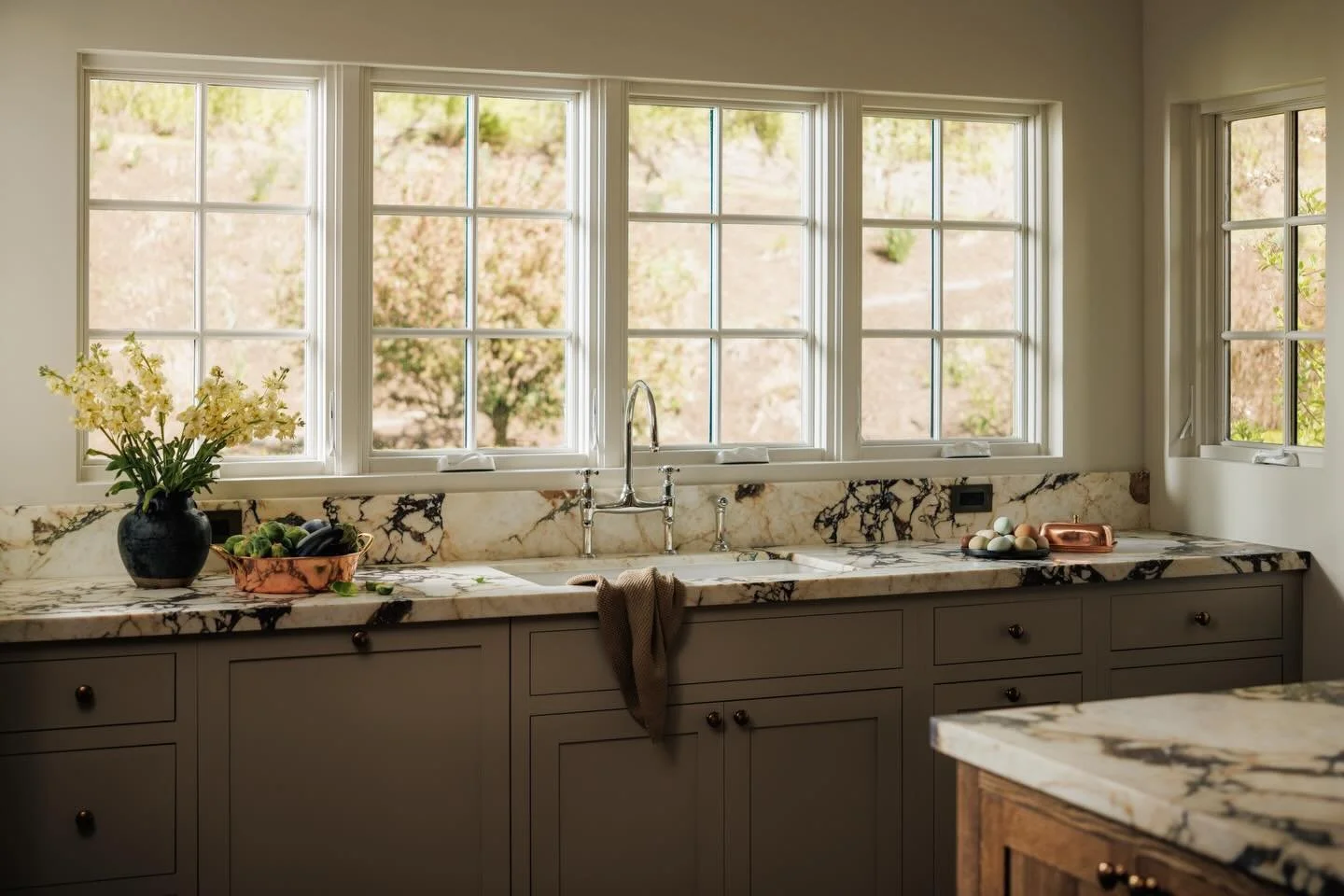 Before and After! 

This used to be one of those rooms that felt nice but a little disconnected. We brought the kitchen into this area, opening everything up and improving flow while keeping all the natural light intact. Proof that relocating walls (