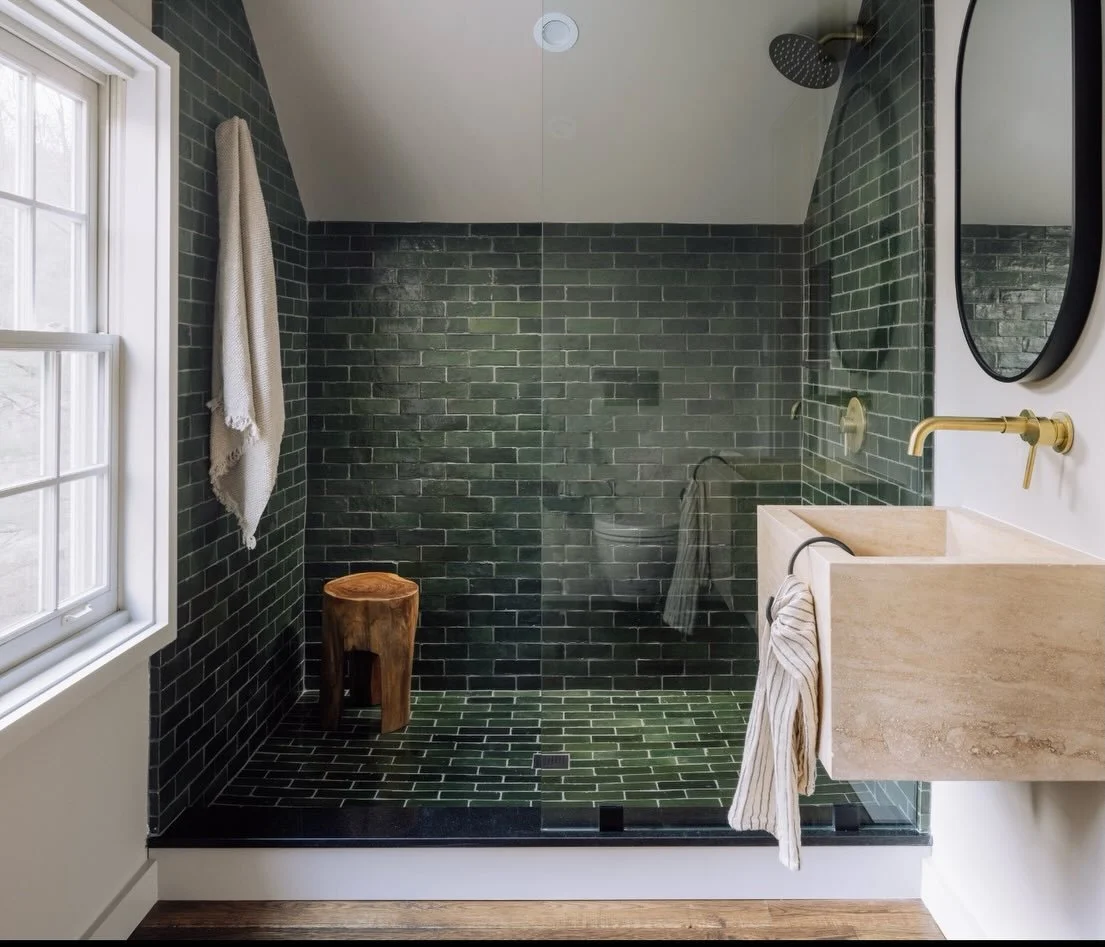Before and after alert! An unfinished attic over the garage went from raw framing and plywood to a bold, cozy guest retreat. We leaned into the angles, mixed dark tile with warm stone, and kept the glass open to let the light do its thing. Smart layo