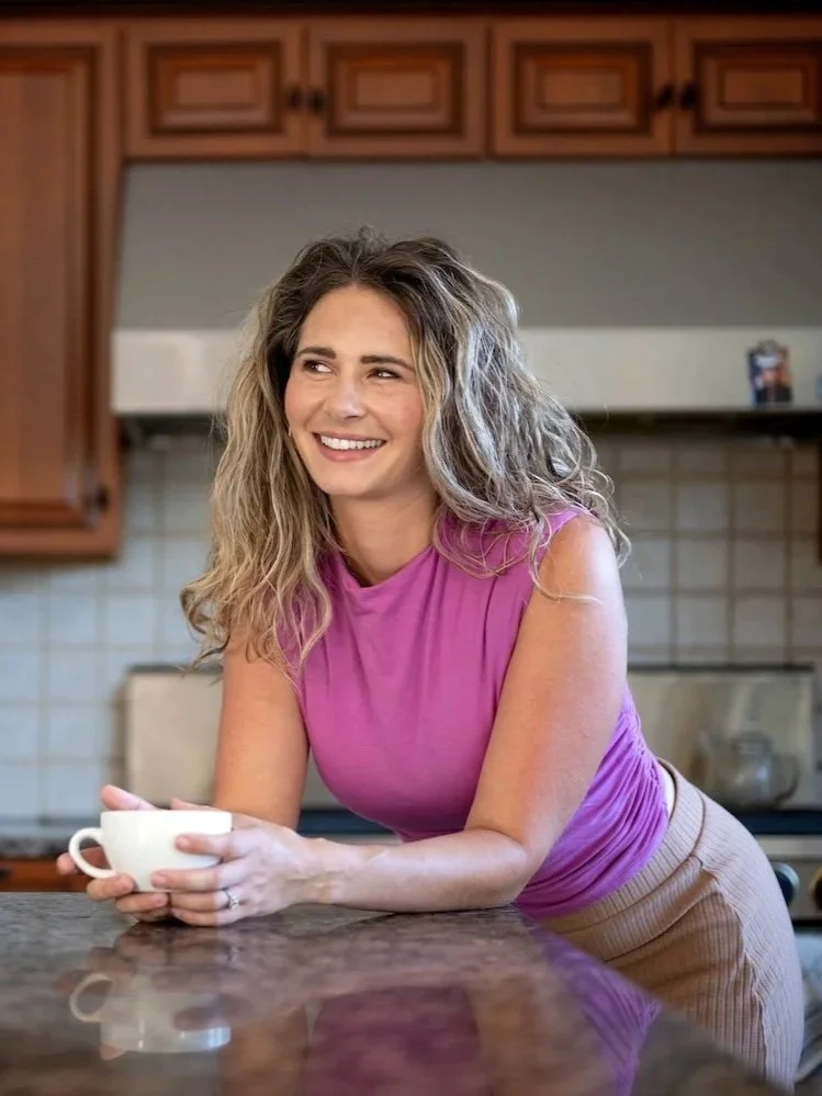 leah brueggemann fdn in kitchen holding coffee mug
