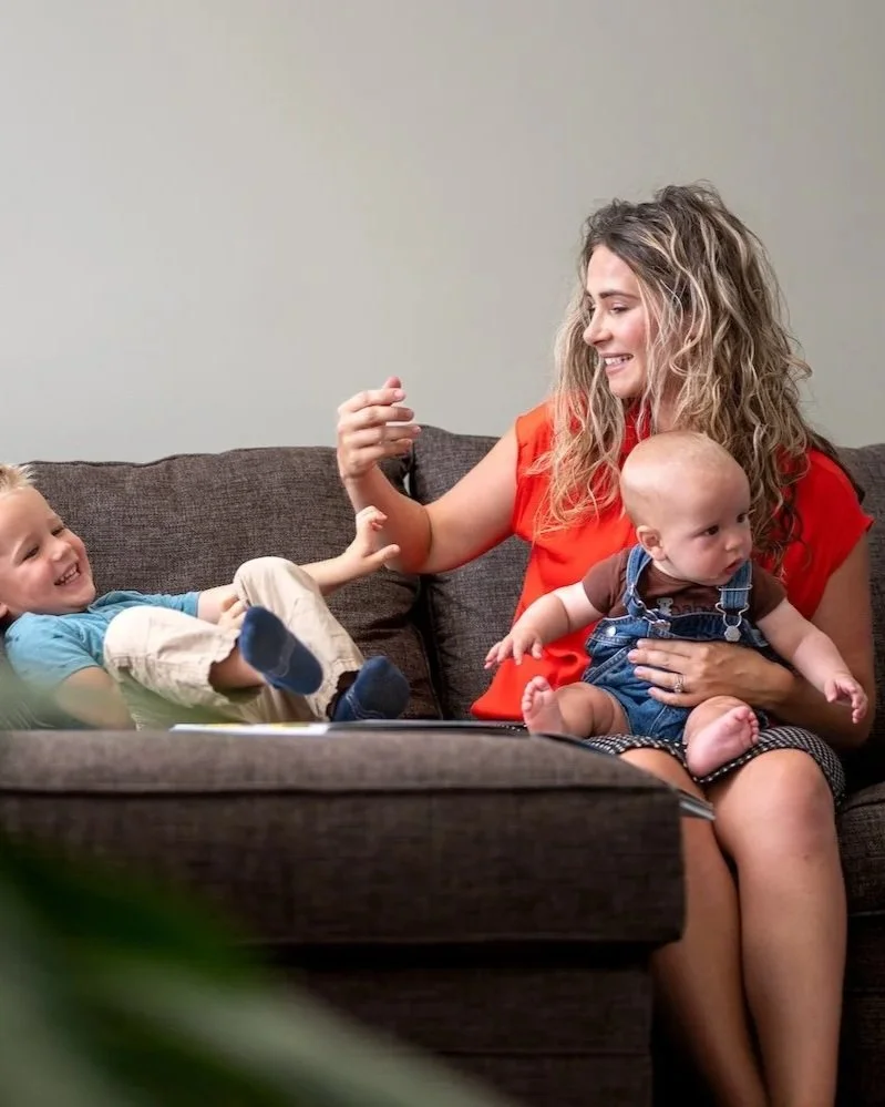 leah brueggemann functional practitioner sitting with sons on couch