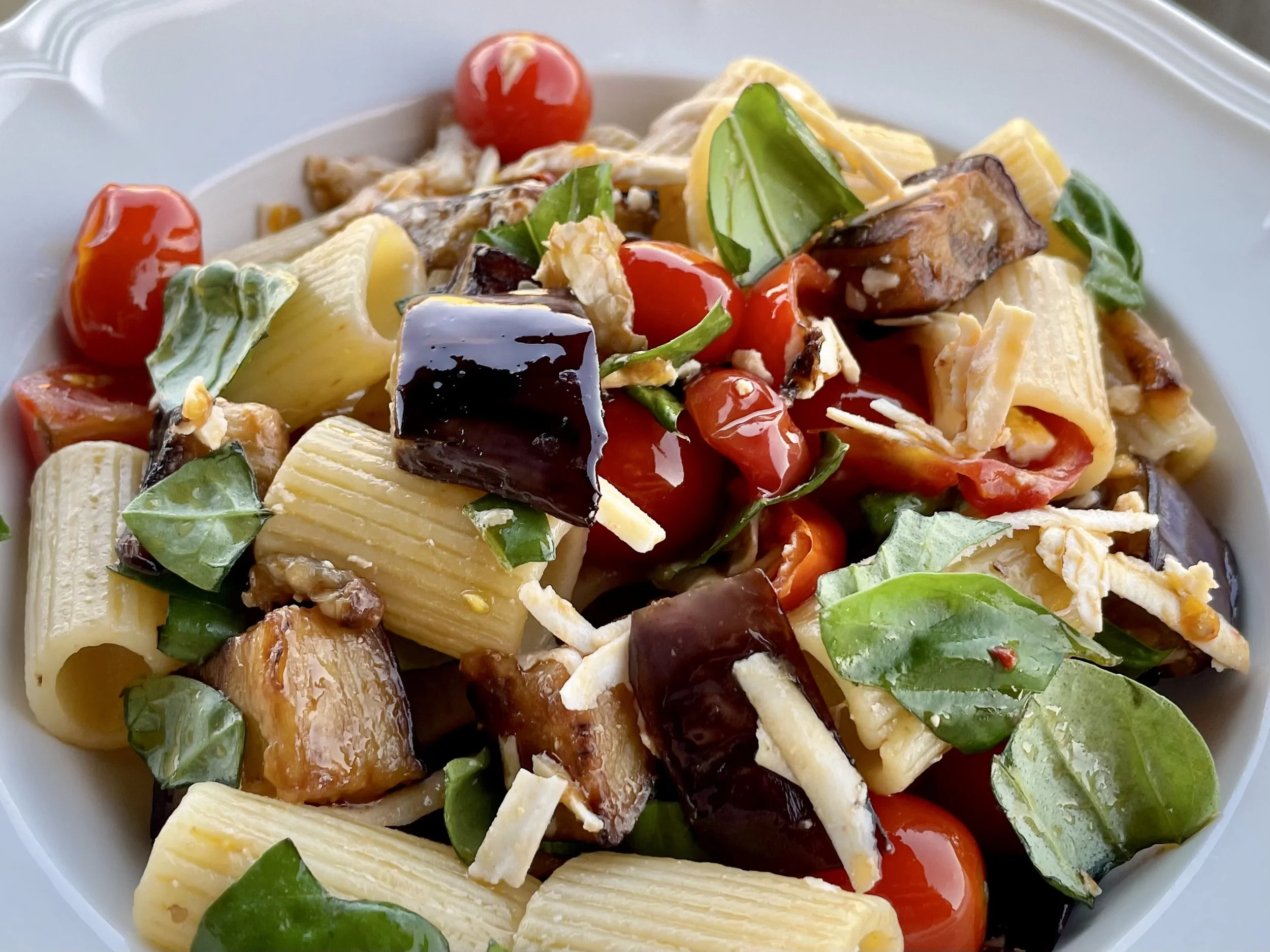 Pasta with eggplant, tomato, basil and cheese