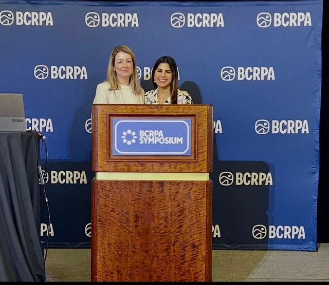 Two women stand in front of podium