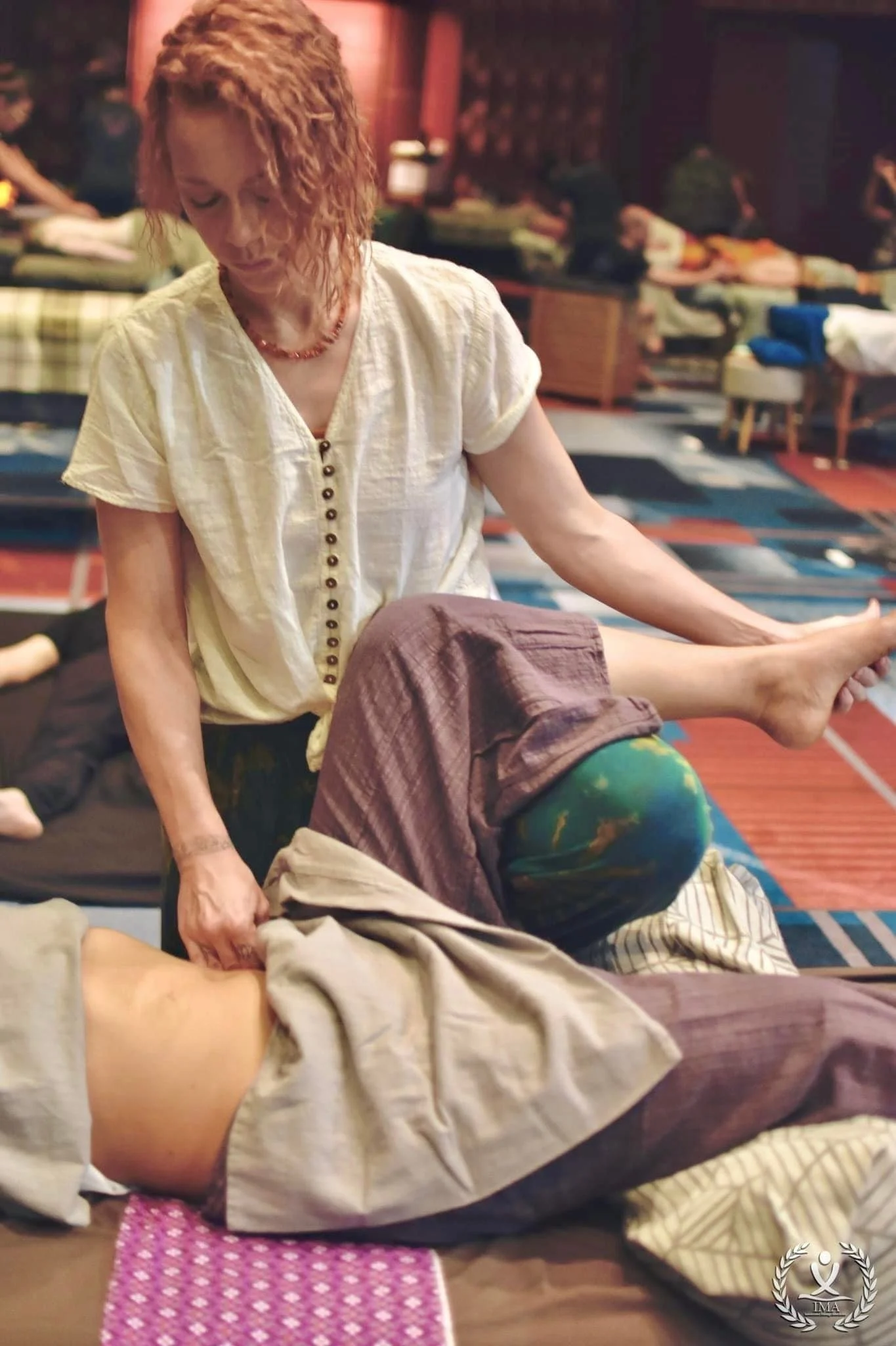 Heather Marie showcasing an abdominal massage technique at the American Massage Championship 2023