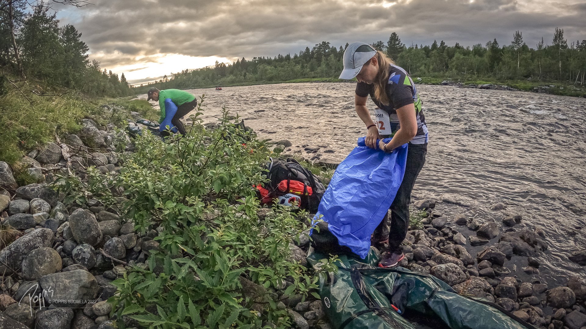 Artident Endurance Team inflating their packrafts by the Näätämöjoki river