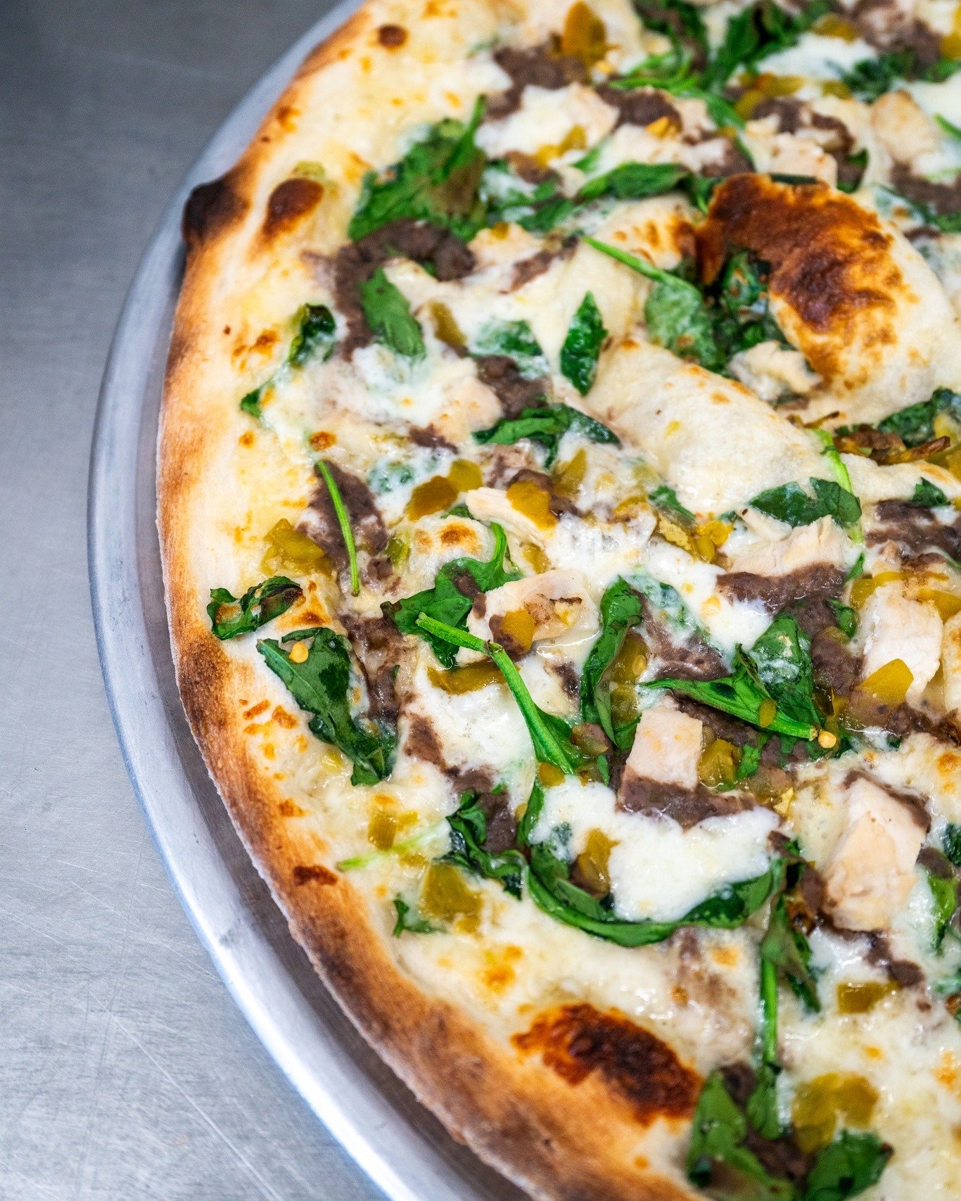 We imagine this is what a tuckered out Cowboy would want to eat after a long day in the hot desert sun. 

The Bandito: Queso sauce, black bean puree, mozzarella, spinach, green chillies, and diced chicken. 🥵

The Bandito is a part of our Summer 2024
