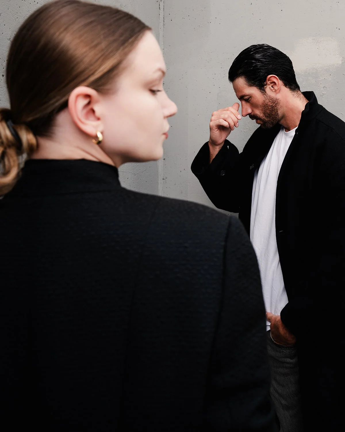 a man and woman seen from profiles on stairwell for fashion shoot