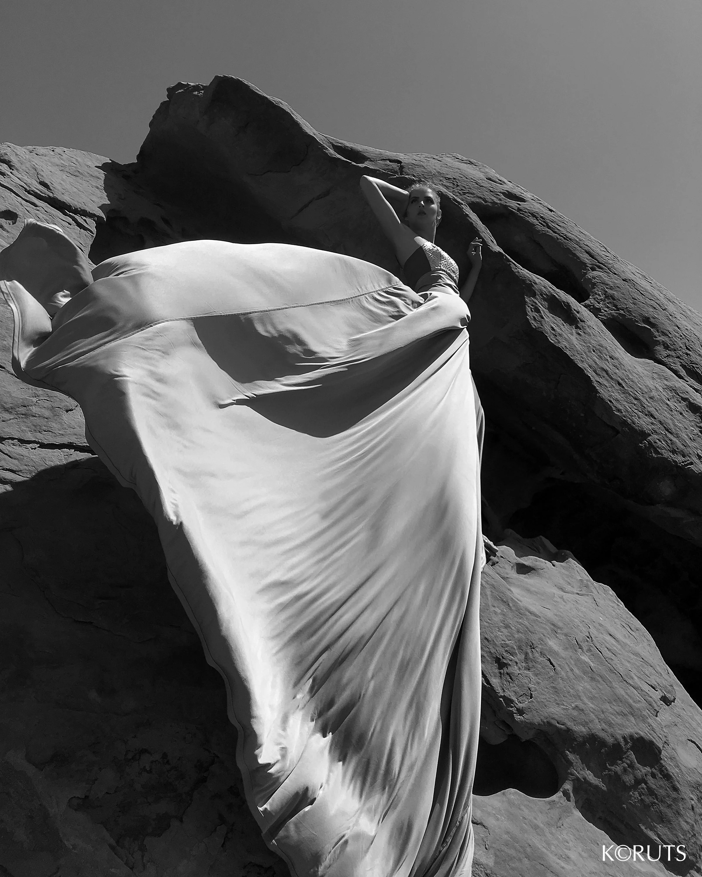 Dress takes the form of a rose while being blown in the dry desert winds