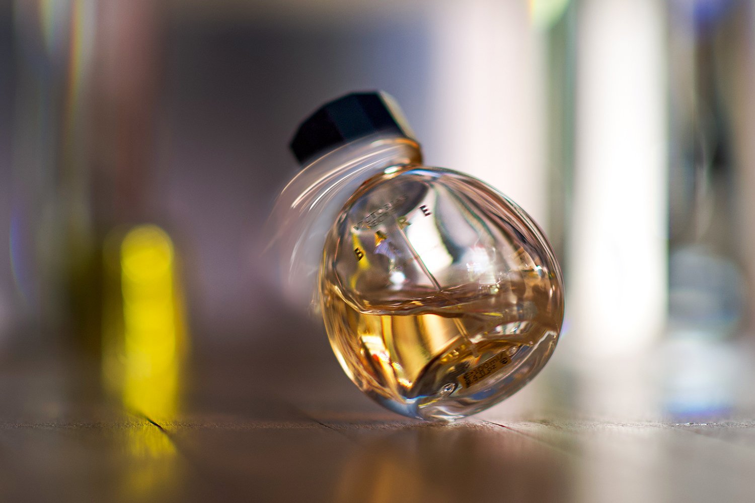 a spinning perfume bottle caught in motion