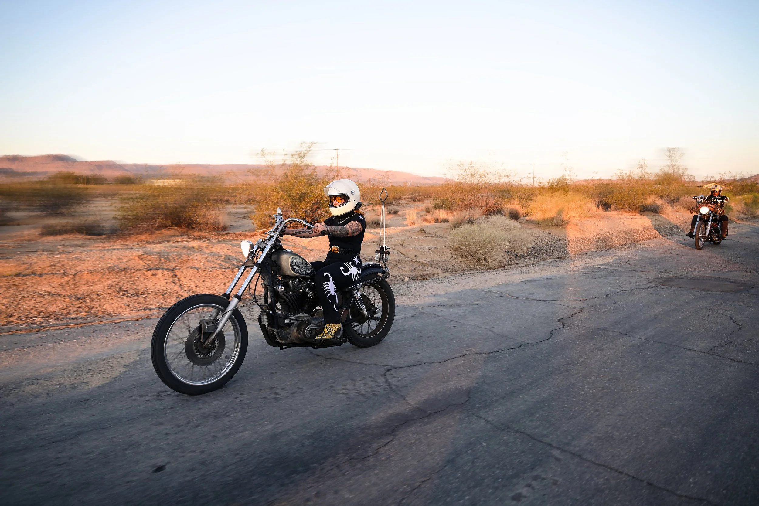 Riders riding in the desert.
