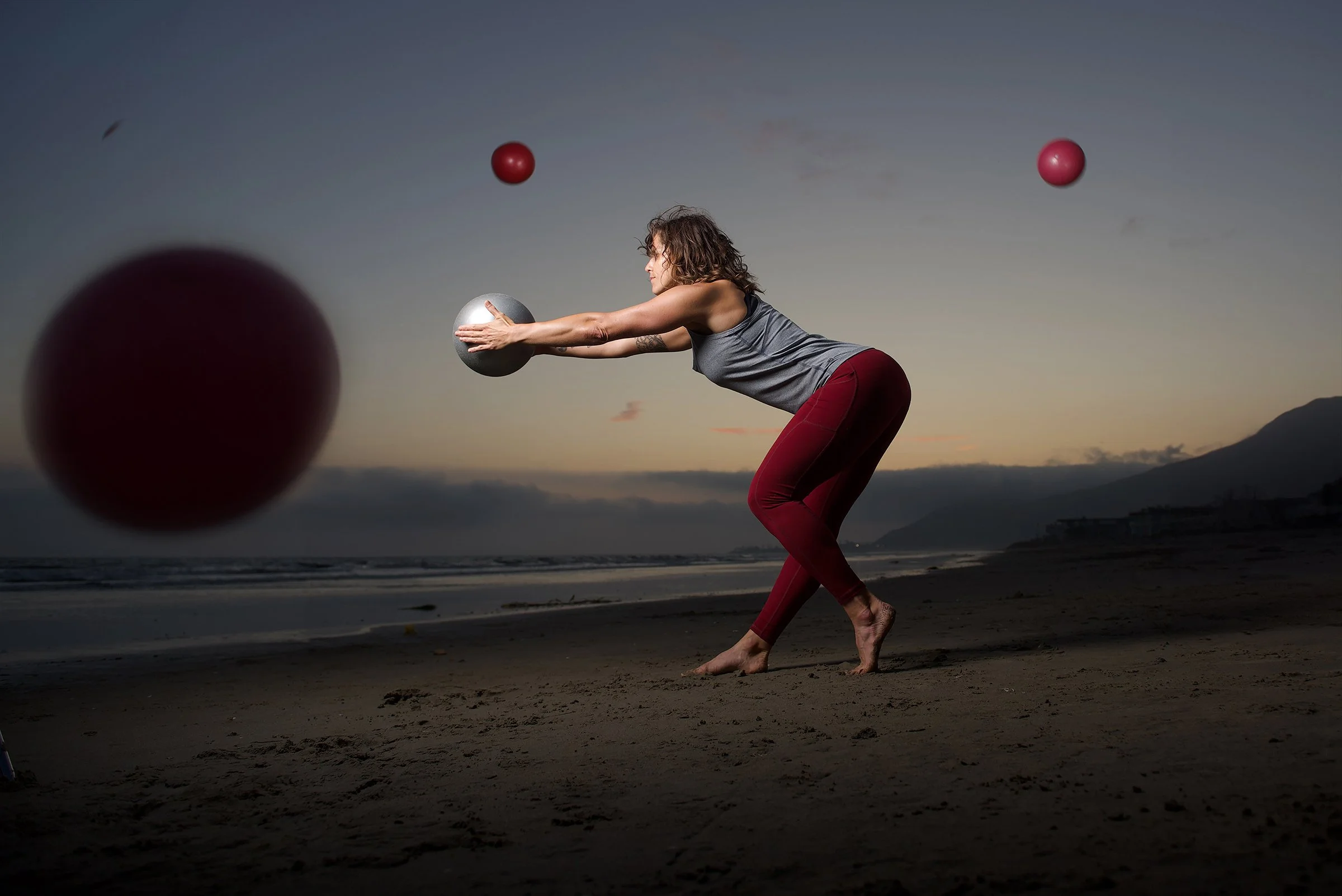Fitness coach displays good form on beach one light shoot