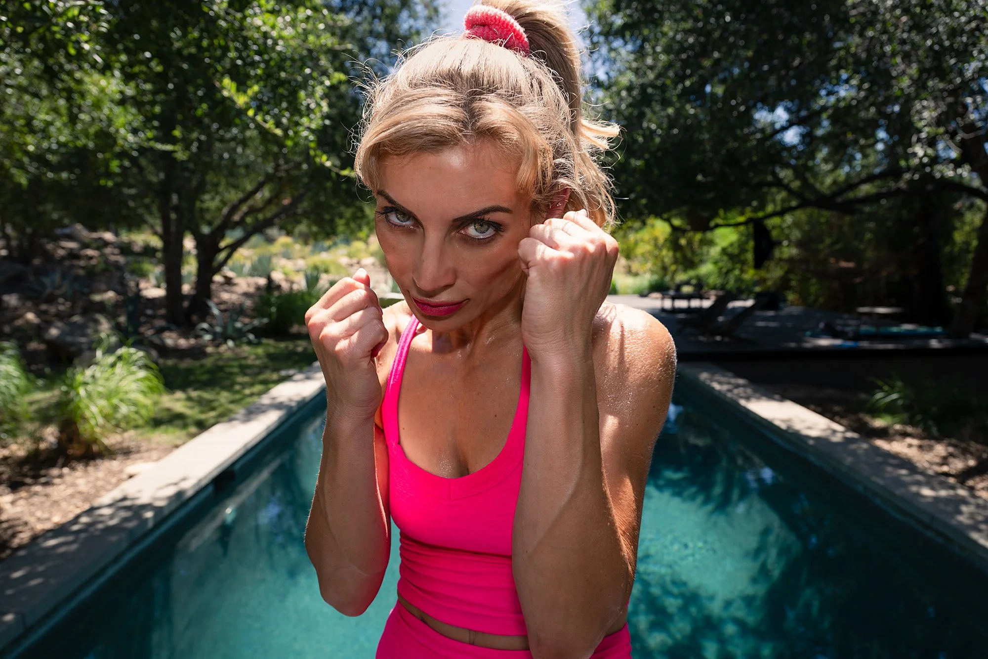 Boxing female staring down the lens in athletic photoshoot.