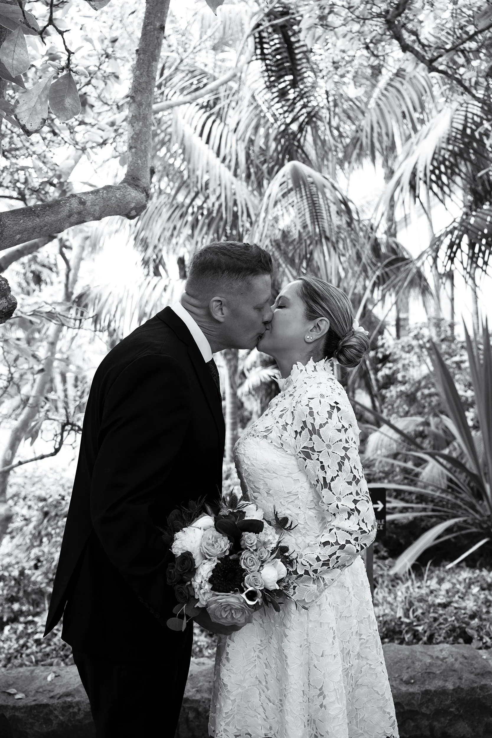 Newly weds kiss in the sunken gardens in santa barbara