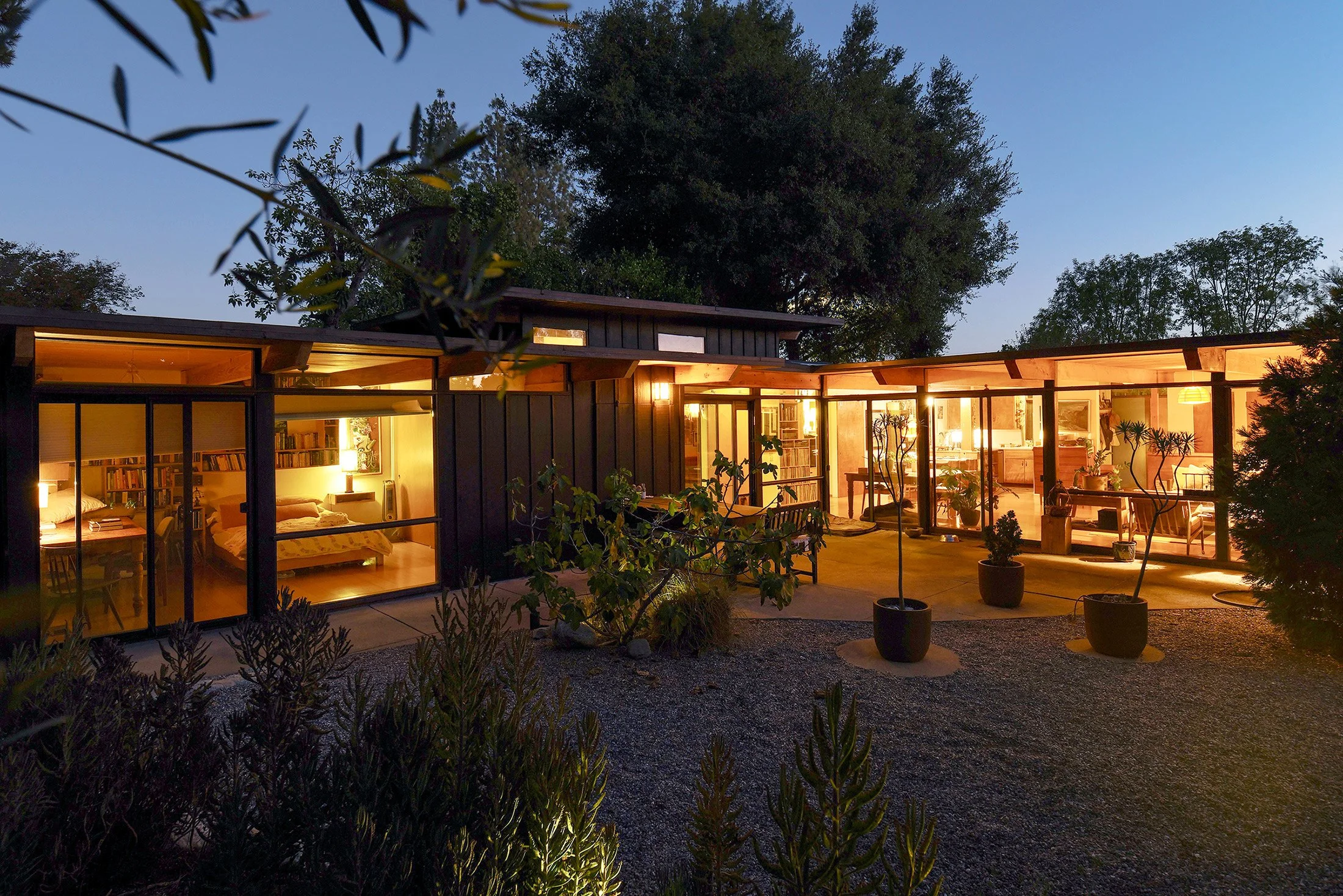 garden view of home illuminated at night -real estate photographer