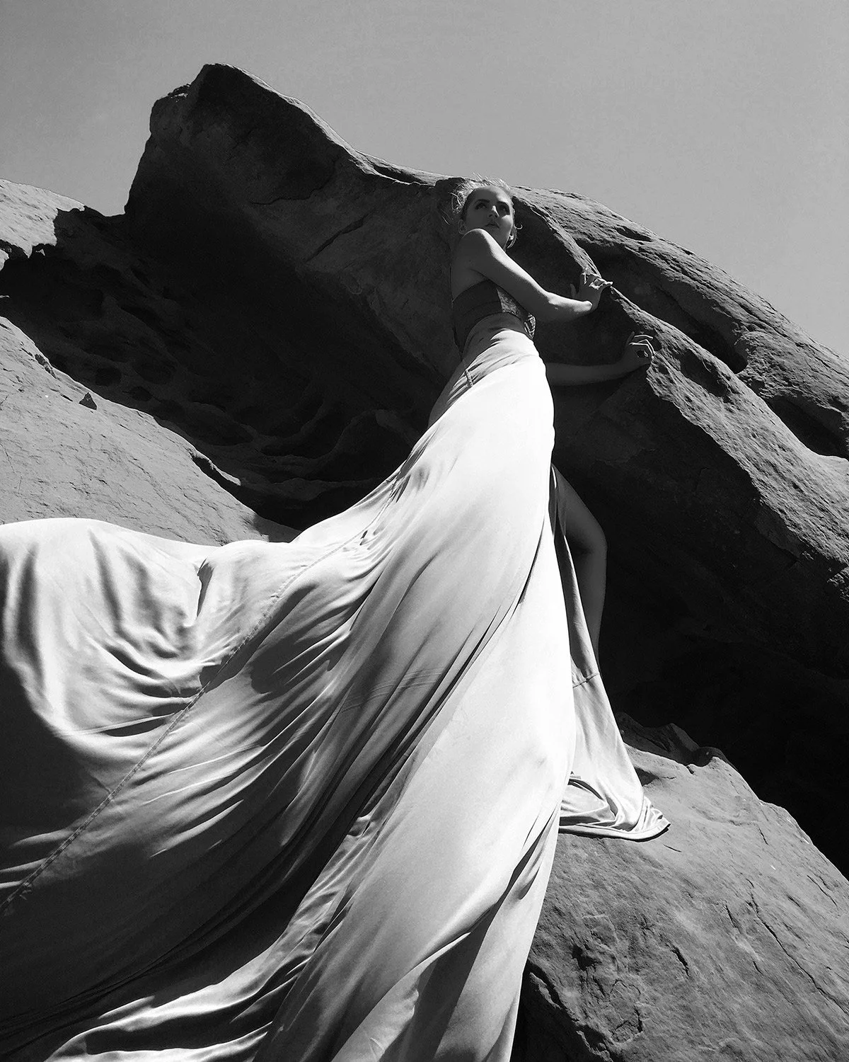 a woman's gown flows in the wind
