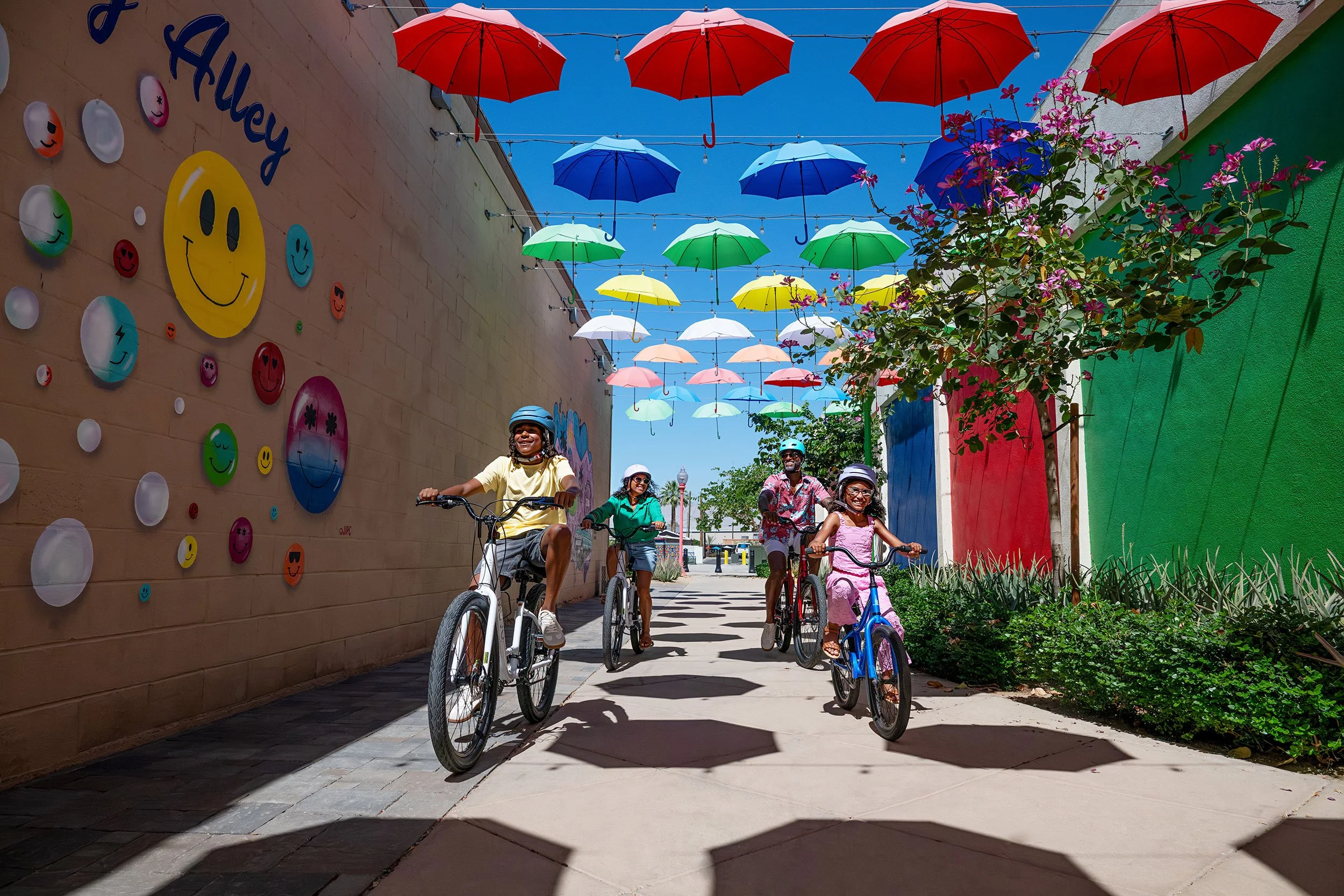 Family enjoying murals on bikes in Palm Springs campagin