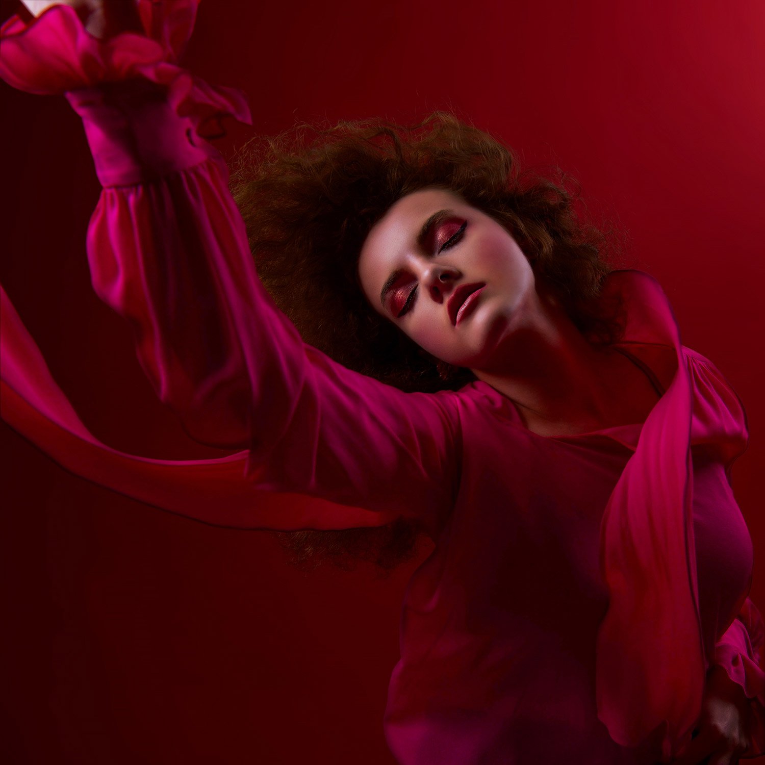 with a dream expression a model wears a fuchsia blouse